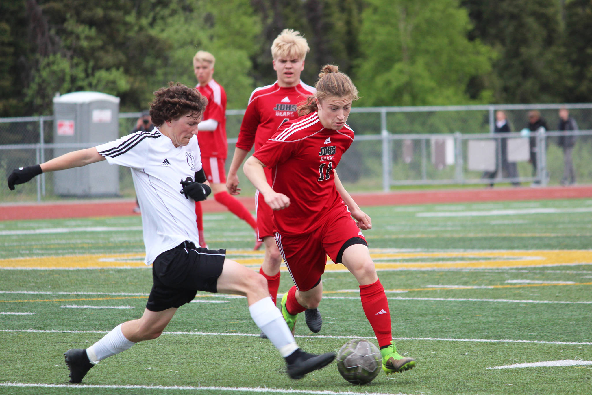 Kenai’s Damien Redder (left) fights for the ball with Juneau’s Jackson Norberg during the championship game of the Division II state soccer tournament Saturday, May 25, 2019 at Service High School in Anchorage, Alaska. (Photo by Megan Pacer/Homer News)