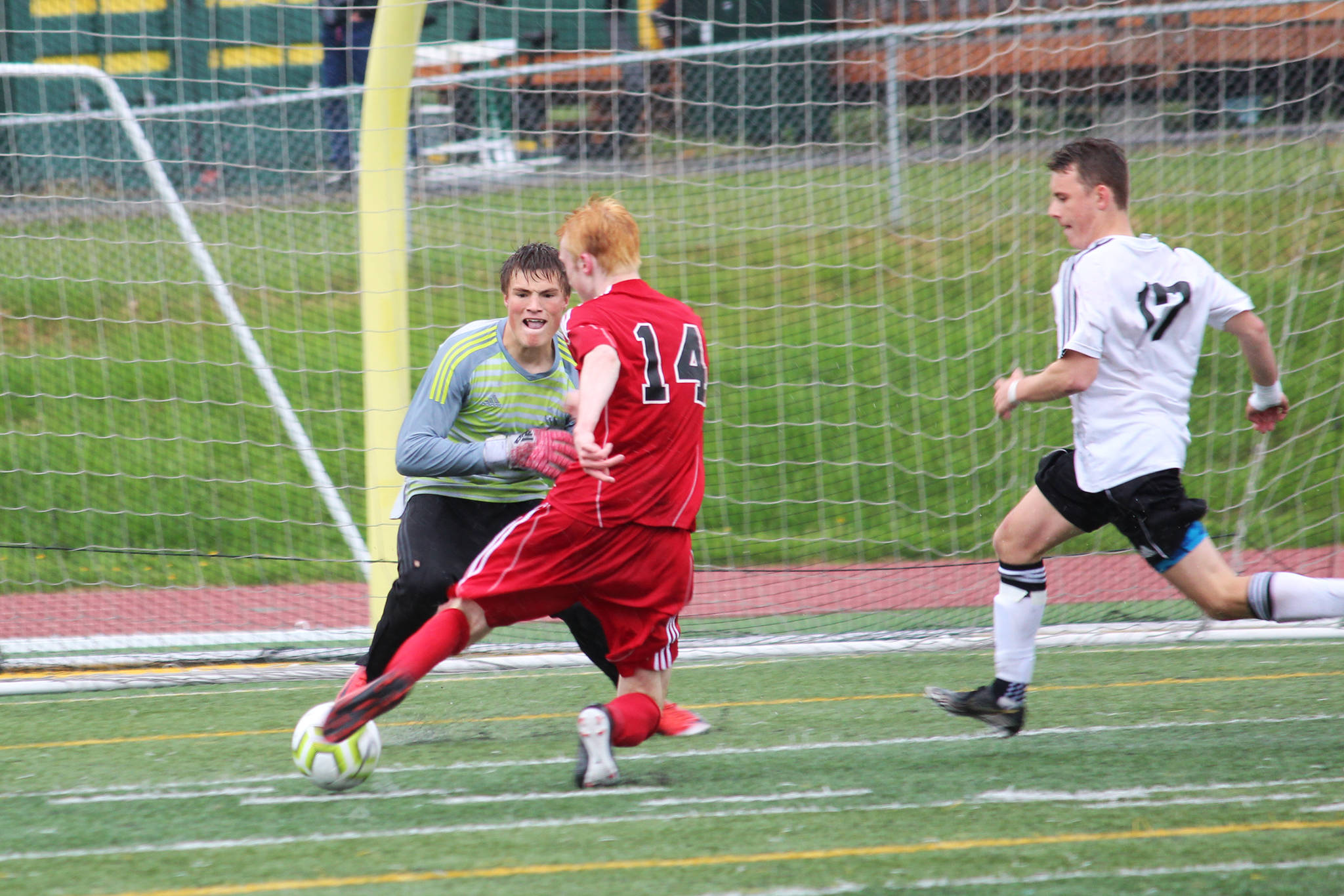 Kenai goalkeeper Braedon Pitsch prepares for a shot from Juneau’s Kannon Goetz during the final game of the Division II state soccer championship tournament Saturday, May 25, 2019 at Service High School in Anchorage, Alaska. (Photo by Megan Pacer/Homer News)