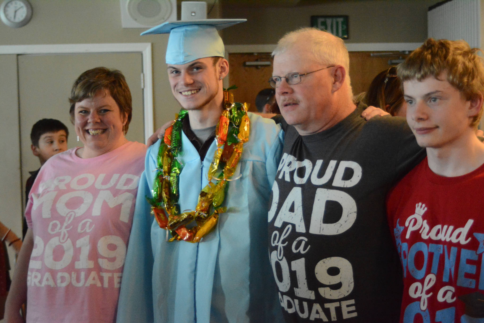 Graduate Sean Moran, second from left, poses with his family after at graduation ceremonies on Wednesday, May 22, 2019, at Land’s End Resort in Homer, Alaska. At left is his mother, Amanda Moran, at far right is his brother, Joseph Moran, and second from right is his father, Donald Moran. (Photo by Michael Armstrong/Homer News)