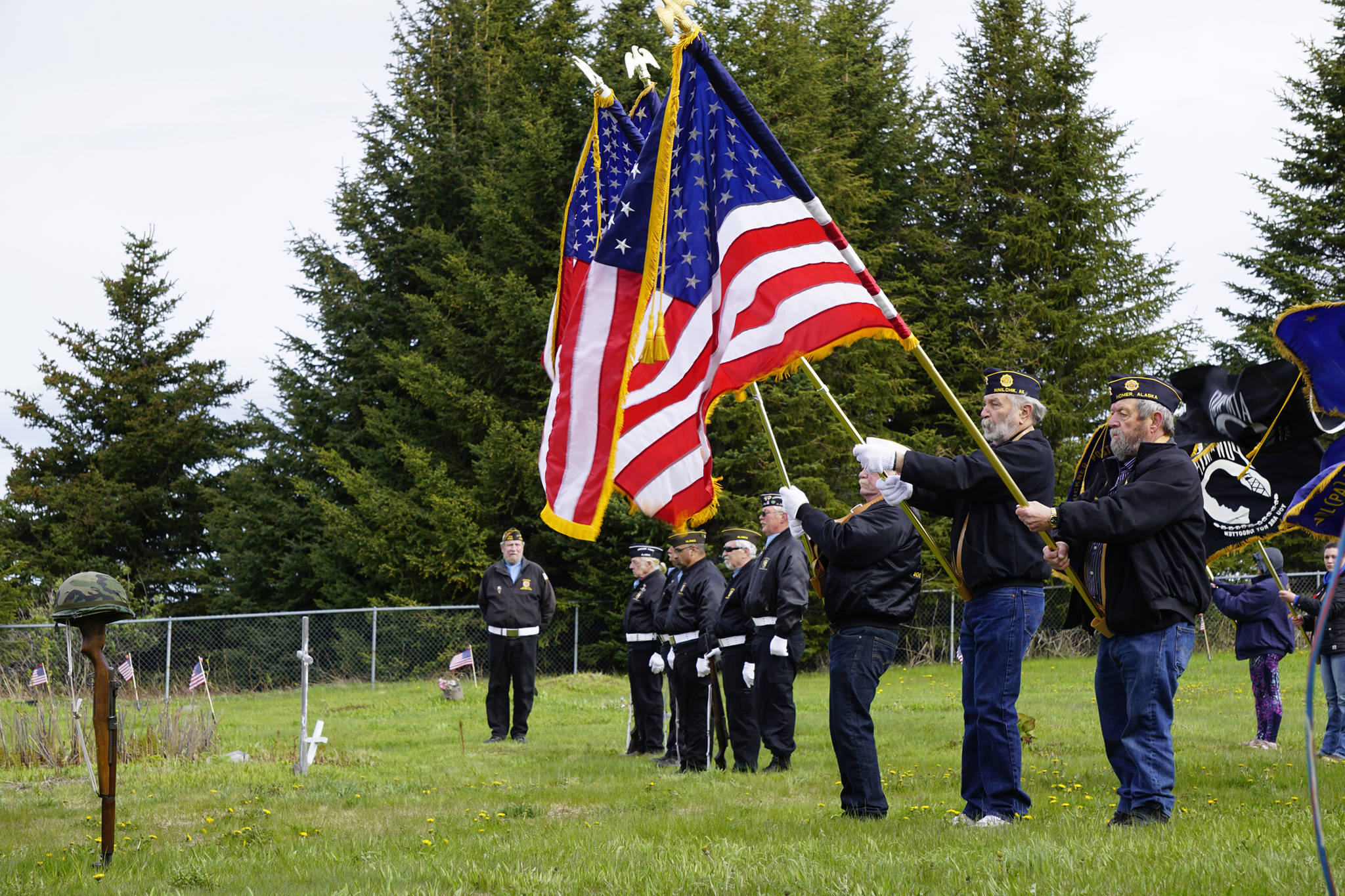 Member of the Veterans of Foreign Wars, Anchor Point, stand at attention during the playing of “Taps” by a bugler with the U.S. Pacific Fleet Band at Memorial Day ceremonies on Monday, May 27, 2019, at Hickerson Memorial Cemetery in Homer, Alaska. About 75 people braved a blustery wind to attend the ceremonies. (Photo by Michael Armstrong/Homer News)