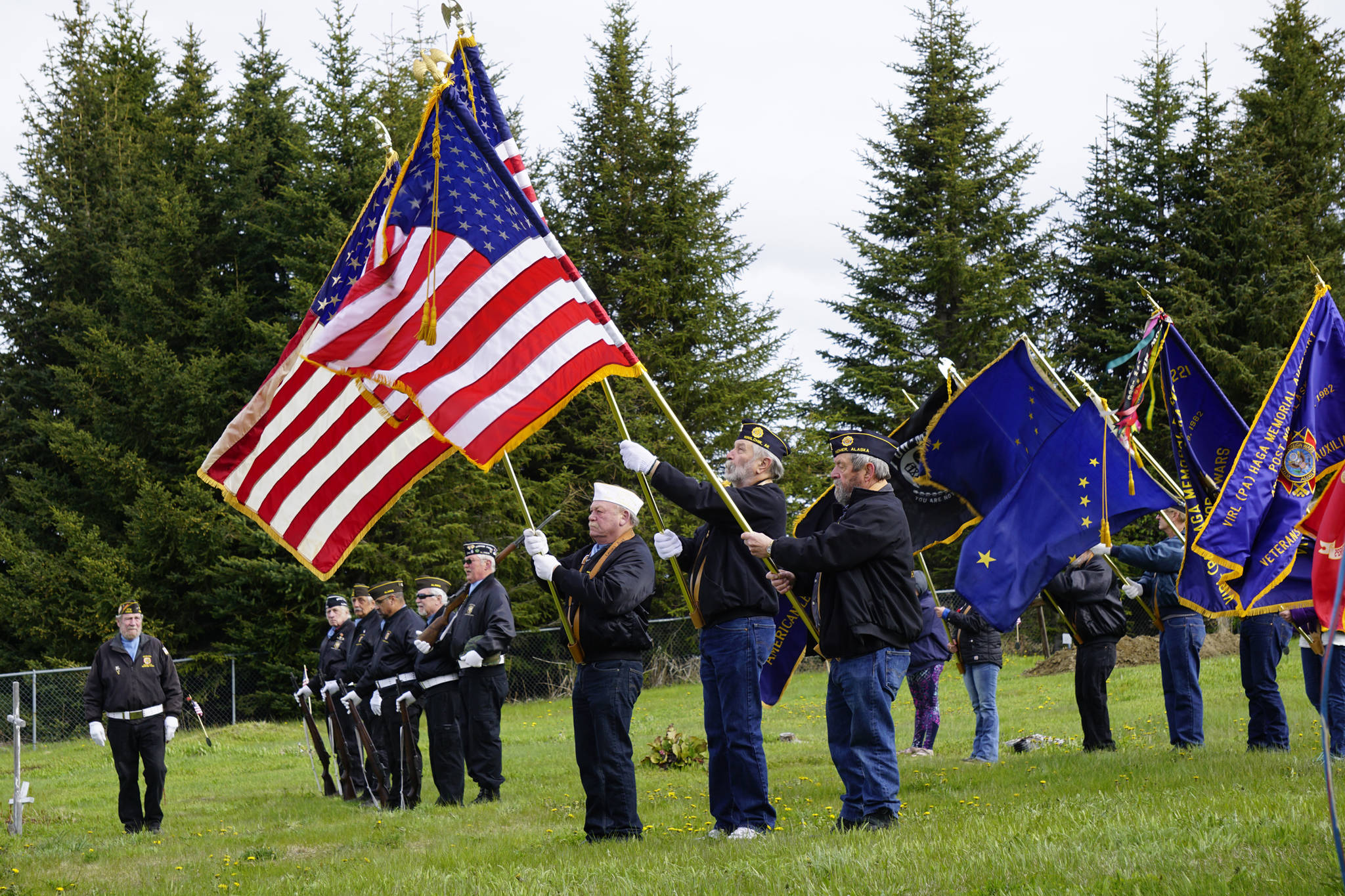 Members of the Veterans of Foreign Wars, the American Legion, Homer and Ninilchik posts, the American Legion Auxiliary and the Sons of the American Legion hold an honor guard at Memorial Day ceremonies on Monday, May 27, 2019, at Hickerson Memorial Cemetery in Homer, Alaska. About 75 people braved a blustery wind to attend the ceremonies. (Photo by Michael Armstrong/Homer News)