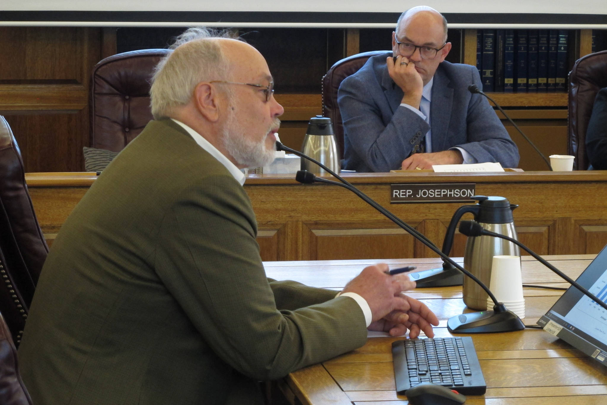 Joe Geldhof, left, testifies before the Alaska House Finance Committee on Thursday, May 23, 2019, in Juneau, Alaska as Rep. Andy Josephson listens. The committee heard a bill that proposes a full Alaska Permanent Fund Dividend this year but seeks changes to the dividend formula going forward. (Becky Bohrer | Associated Press)