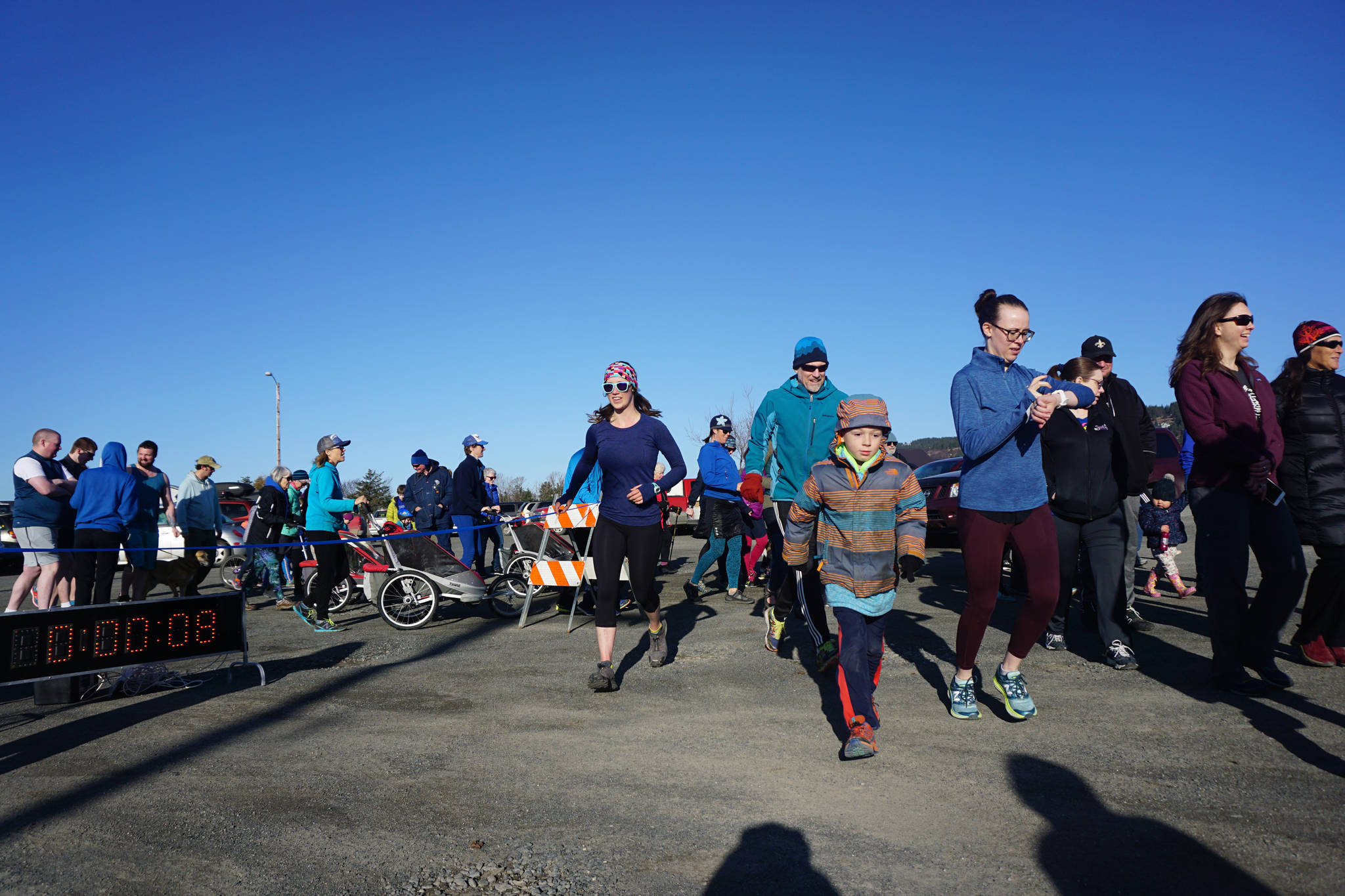 Runners and walkers participate in the Blue Line Run in Homer, Alaska, on March 30, 2019. They moved along the blue line, or the line marking the top of the 50-foot high inundation zone in the event of a tsunami. (Photo provided)