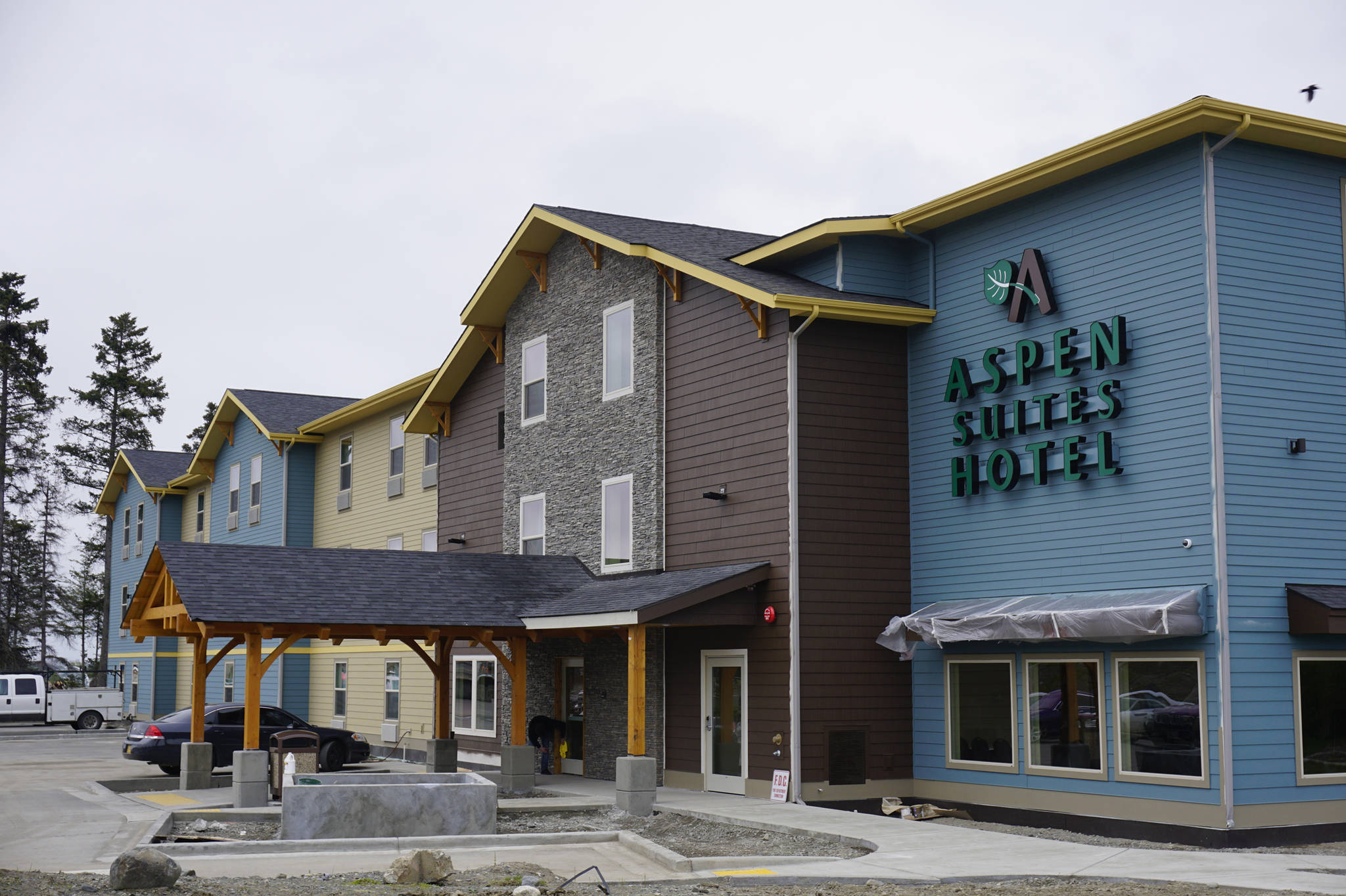 Workers finish up the new Homer Aspen Suites Hotel on May 21, 2019, in Homer, Alaska. (Photo by Michael Armstrong/Homer News)