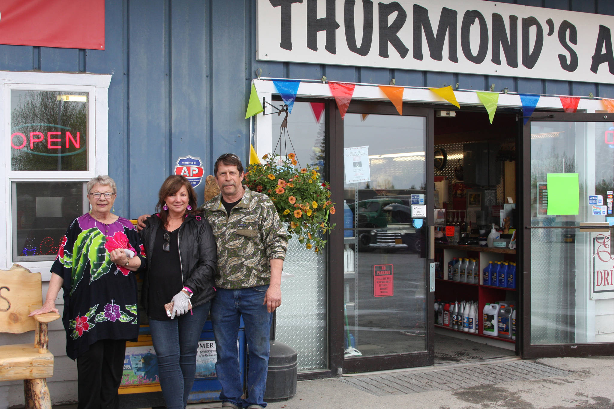 From left to right, Vanita Thurmond, Elaine Griner, and Dale Griner stand outside Thurmond’s Far West Auto in Anchor Point, Alaska at the fifth annual Customer Appreciation Day on Saturday, May 25, 2019. (Photo by Delcenia Cosman)