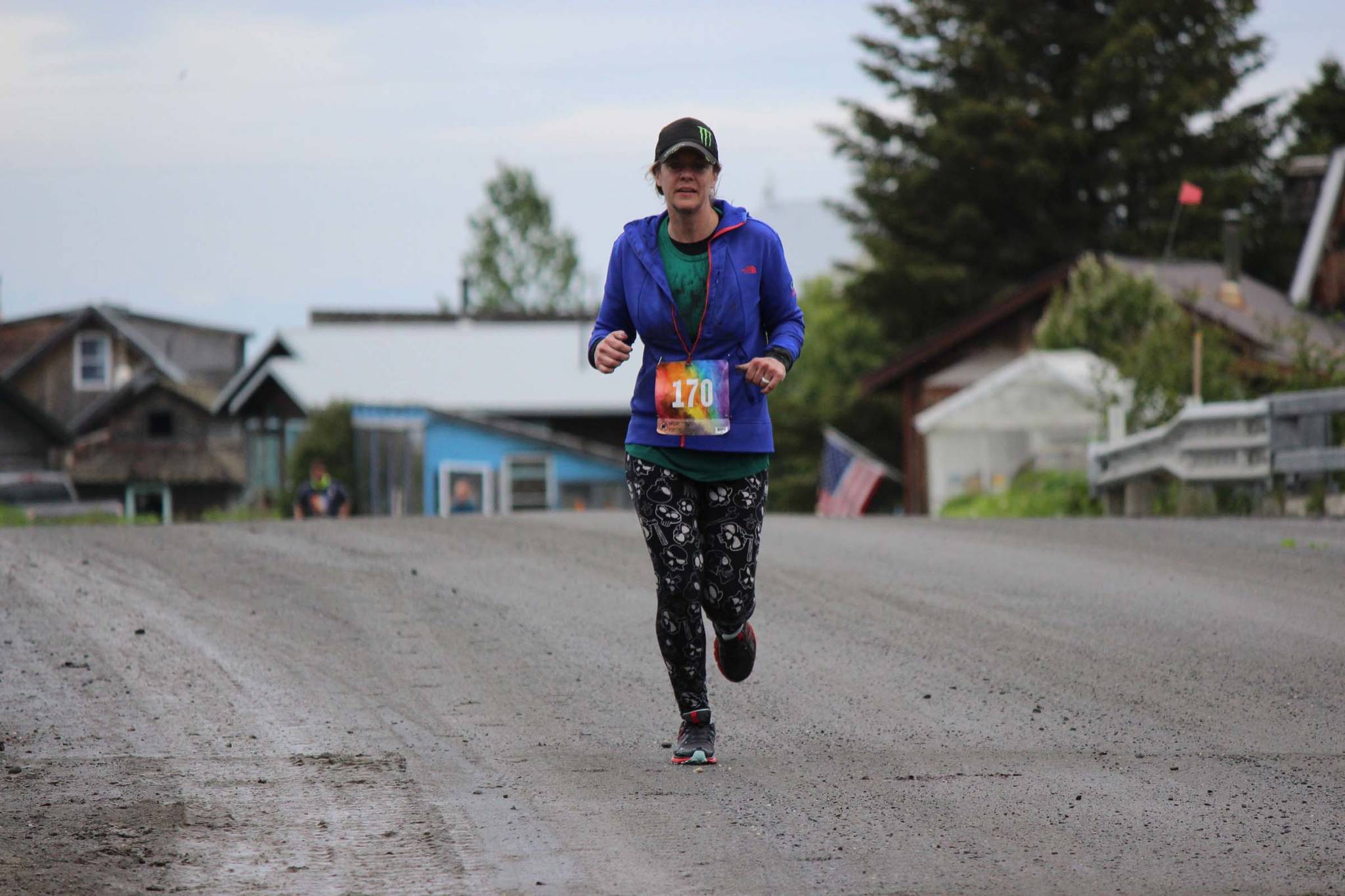 Megan Anderson runs through historic Ninilchik Village for the Clam Scramble held Saturday, June 15, 2019 in Ninilchik, Alaska. (Photo by McKibben Jackinsky)