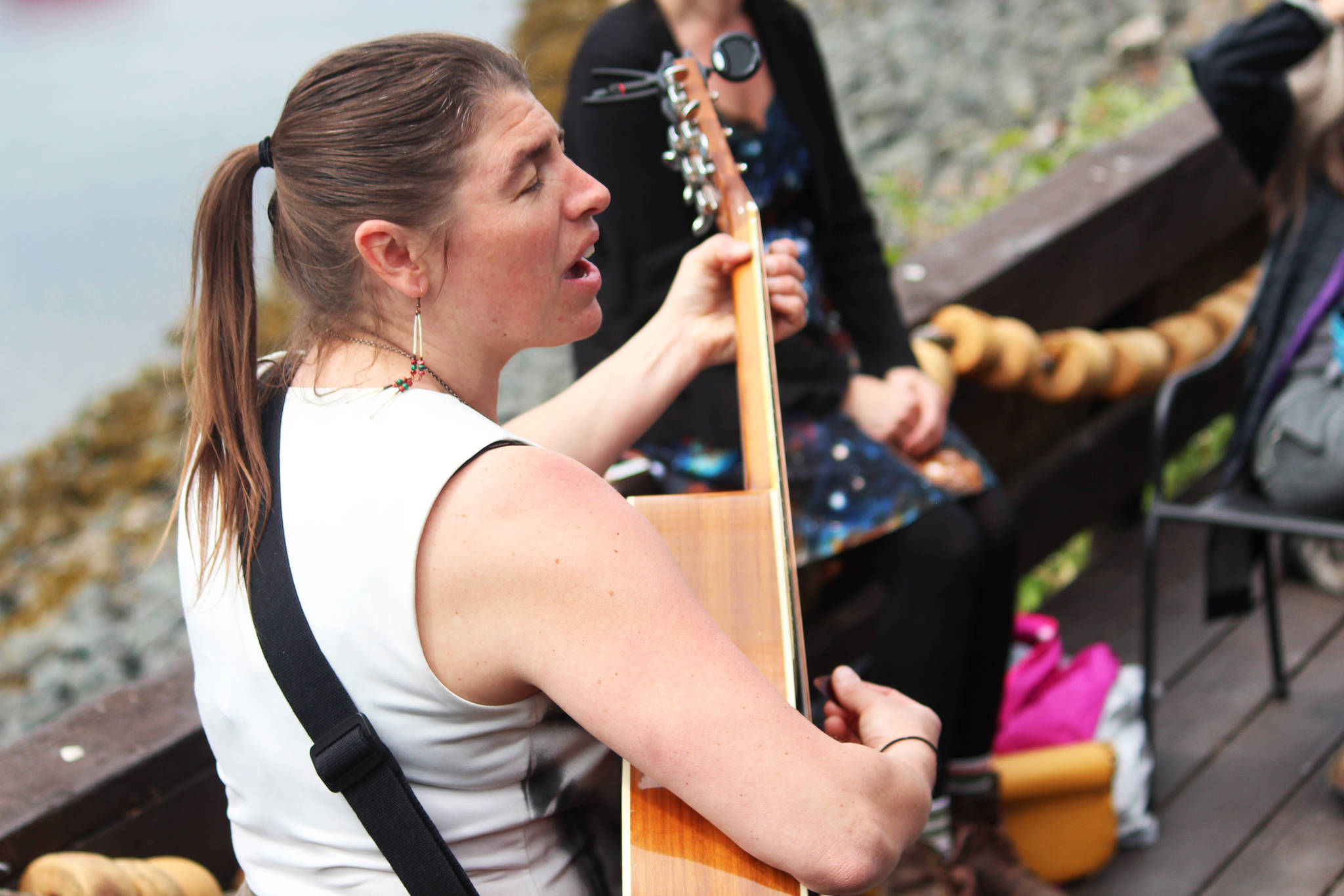Kat Moore performs a set on Friday, June 21, 2019 at the Seldovia Boardwalk Hotel as part of a round of street performances during the Seldovia Summer Solstice Music Festival in Seldovia, Alaska. (Photo by Megan Pacer/Homer News)
