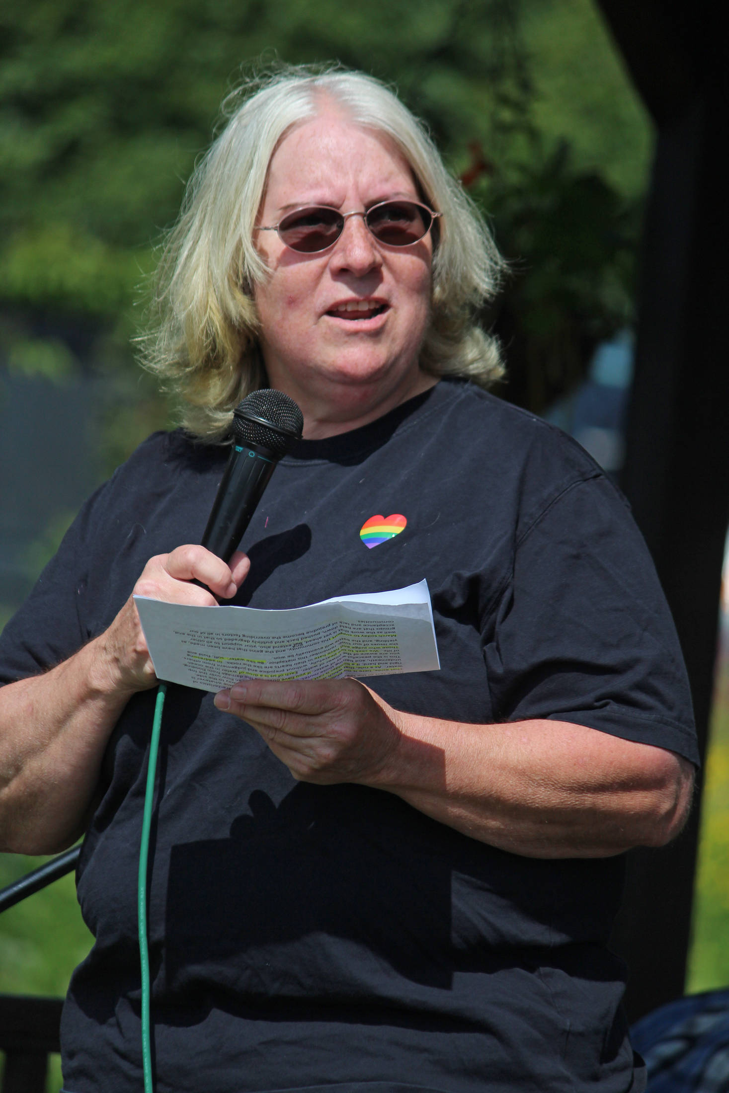 Martie Krohn speaks to a crowd of people before the second Homer Pride Walk on Saturday, June 22, 2019 at WKFL Park in Homer, Alaska. (Photo by Megan Pacer/Homer News)