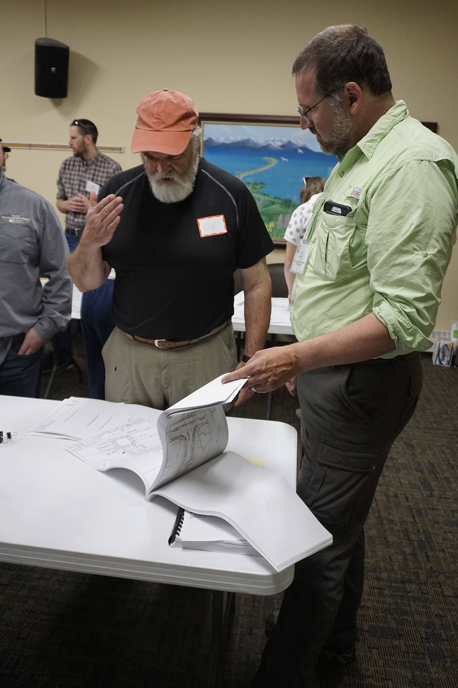 Homer Mayor Ken Castner, left, talks about the Lake Street rehabilitation project with Alaska Department of Transportation and Public Facilities Project Manager Clint Adler at a public meeting on current and upcoming ADOT&PF projects on June 25, 2019, at Homer City Hall, Homer, Alaska. (Photo by Michael Armstrong/Homer News)