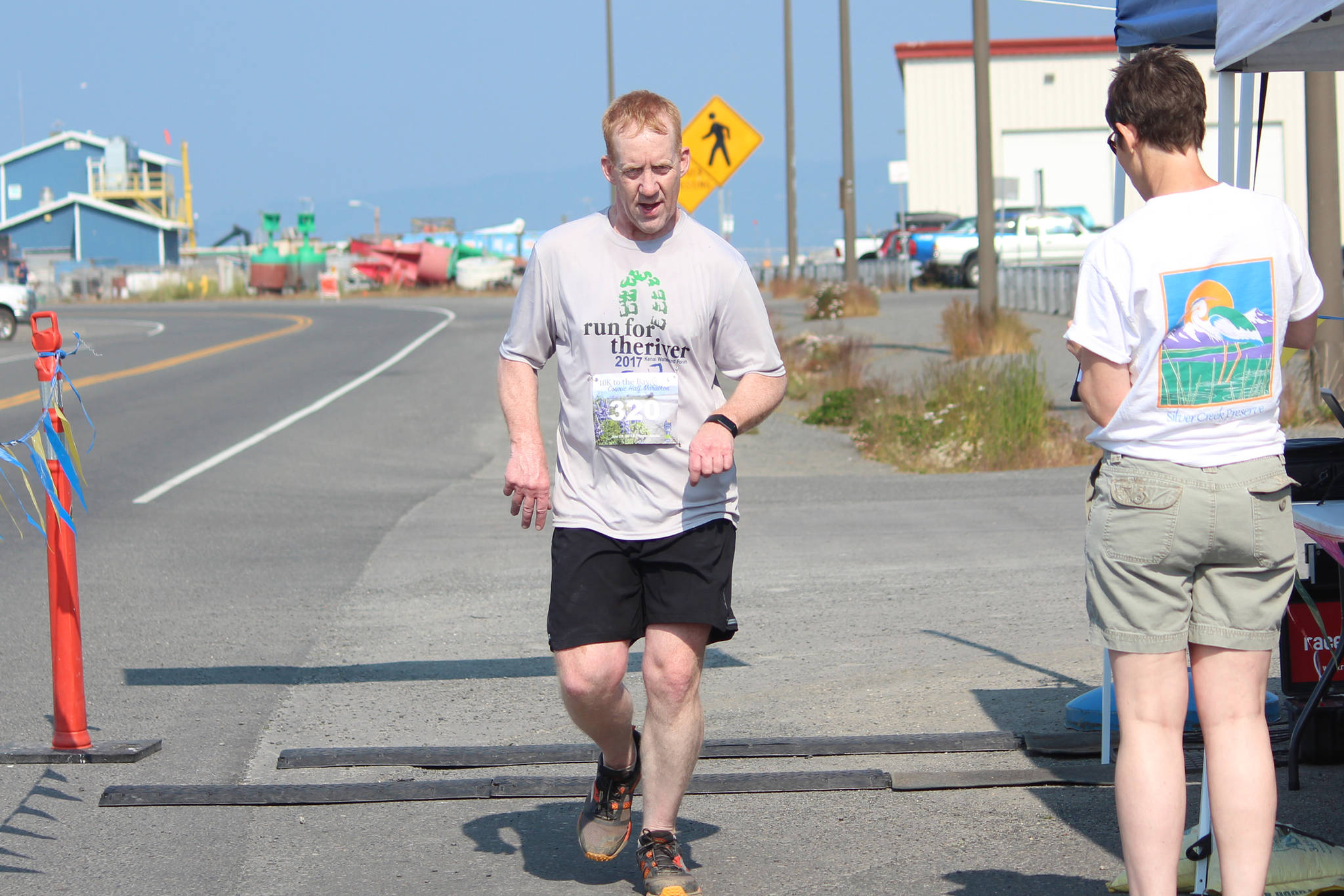 Soldotna’s Kent Petersen crosses the finish line of the Spit Run 10k to the Bay on Saturday, June 29, 2019 in Homer, Alaska. (Photo by Megan Pacer/Homer News)
