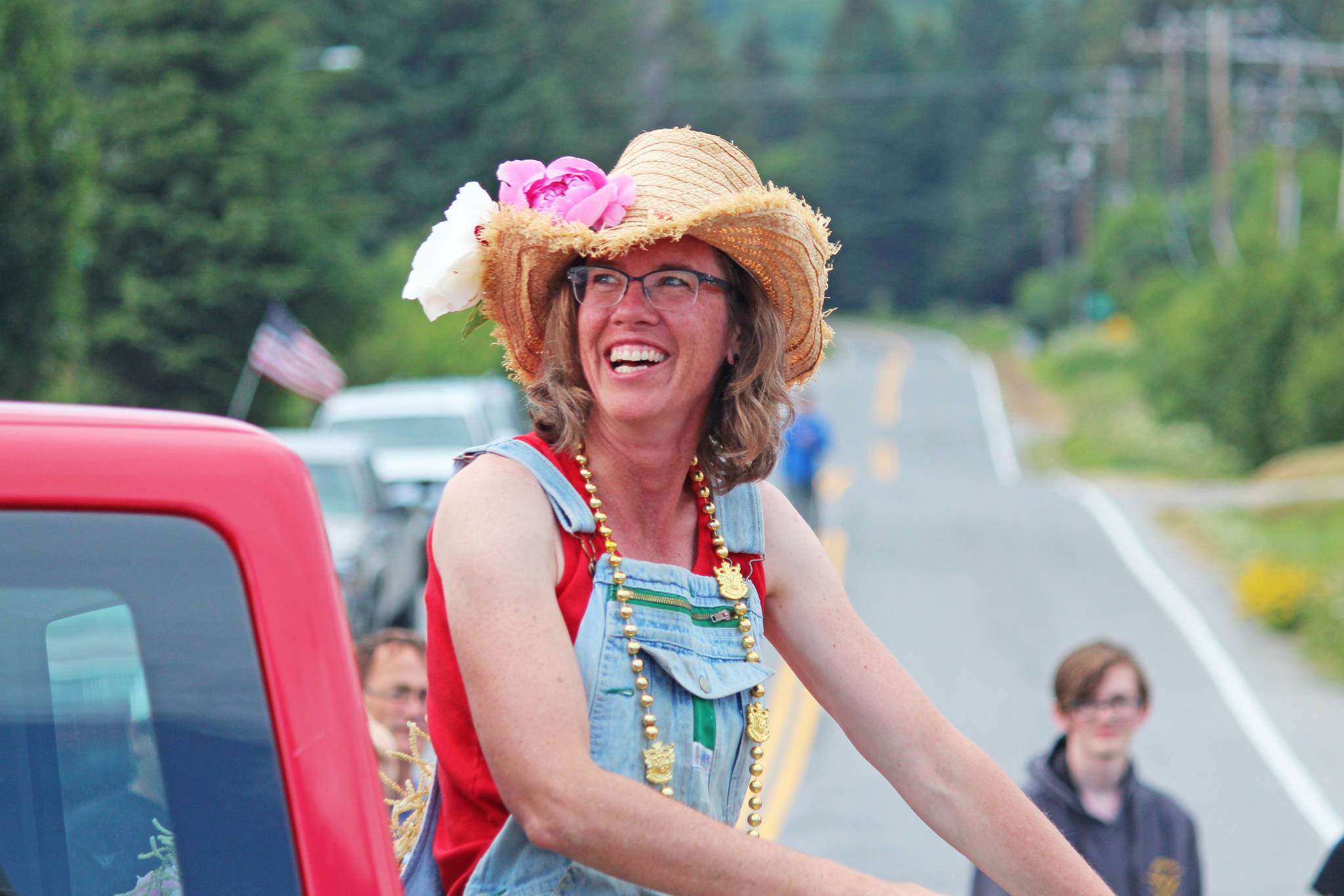 Kyra Wagner, the grand marshal for this year’s July Fourth parade hosted by the Homer Chamber of Commerce, smiles while riding along the parade route Thursday, July 4, 2019 on Pioneer Avenue in Homer, Alaska. (Photo by Megan Pacer/Homer News)