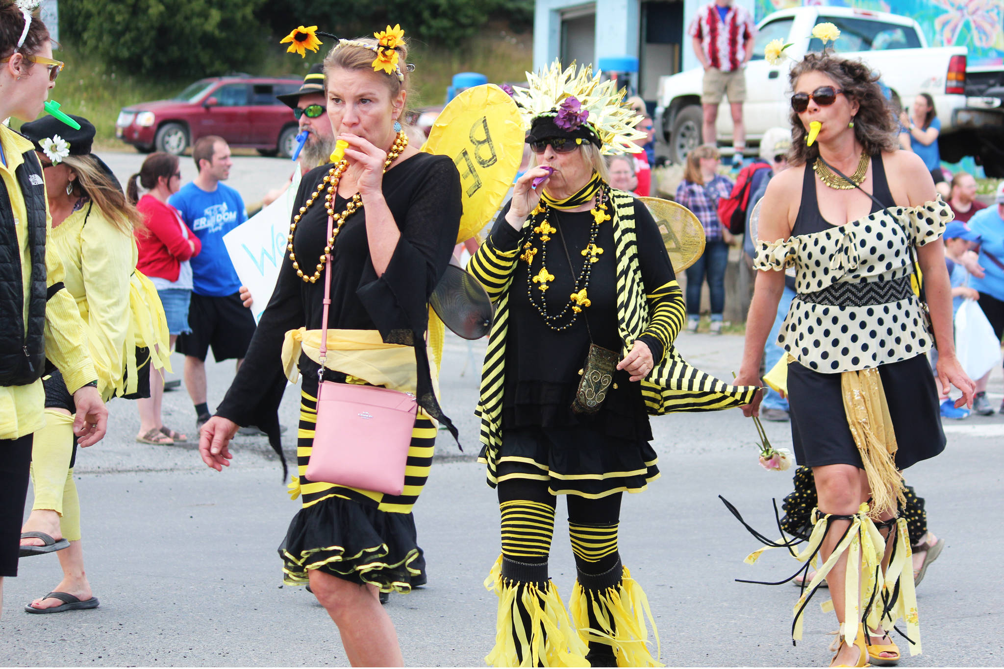 A group of parade participants marsh dressed as bees to raise awareness for supporting the insects and agriculture in general during this year’s July Fourth parade Thursday, July 4, 2019 on Pioneer Avenue in Homer, Alaska. (Photo by Megan Pacer/Homer News)