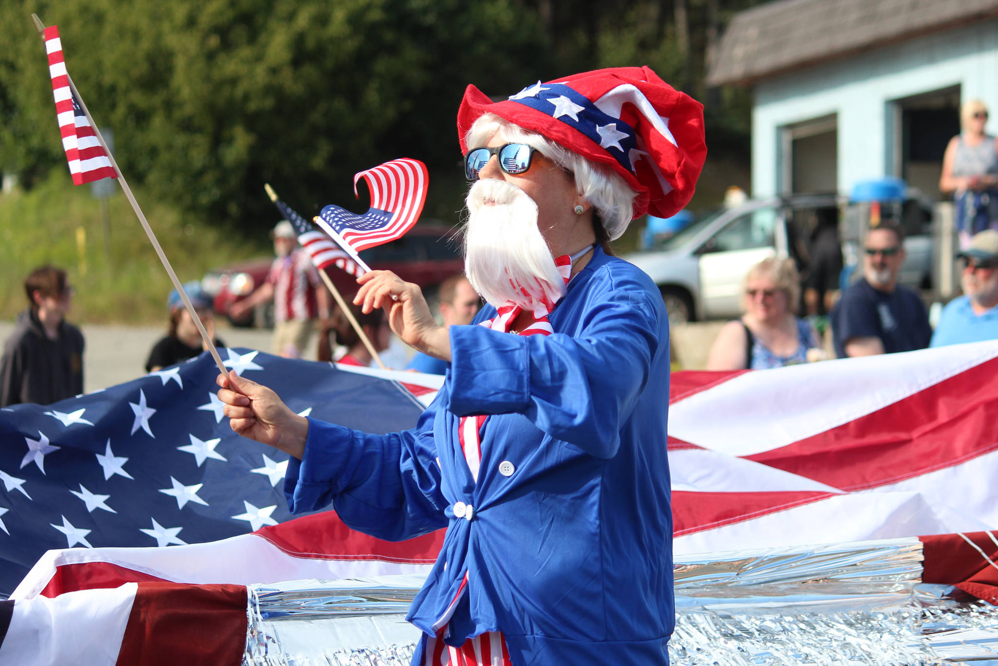 A member of the Homer Senior Citizens Center float marches in this year’s July Fourth parade on Thursday, July 4, 2019 on Pioneer Avenue in Homer, Alaska. (Photo by Megan Pacer/Homer News)
