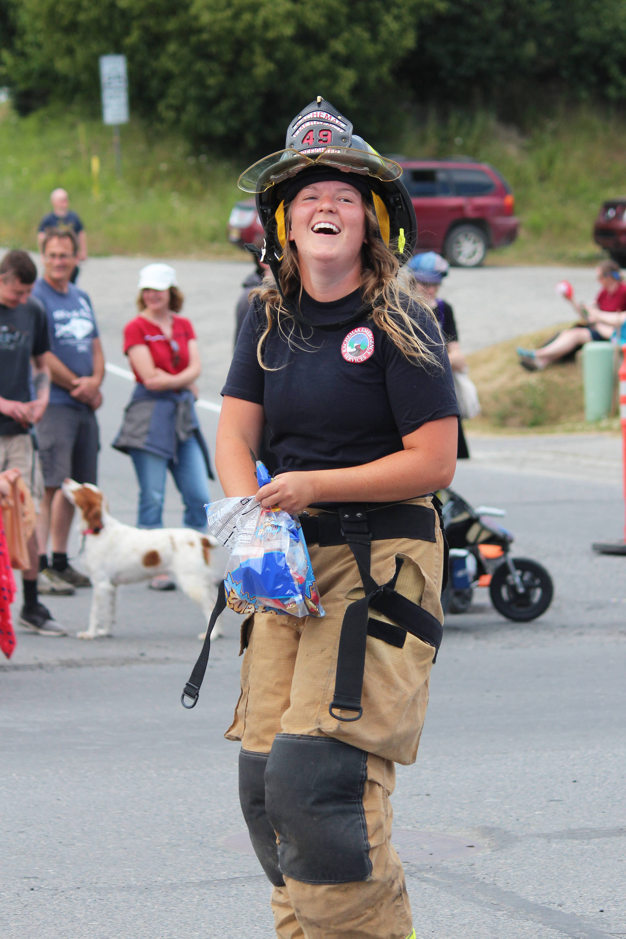A member of Kachemak Emergency Services smiles as she throws candy to spectators at this year’s July Fourth parade.
