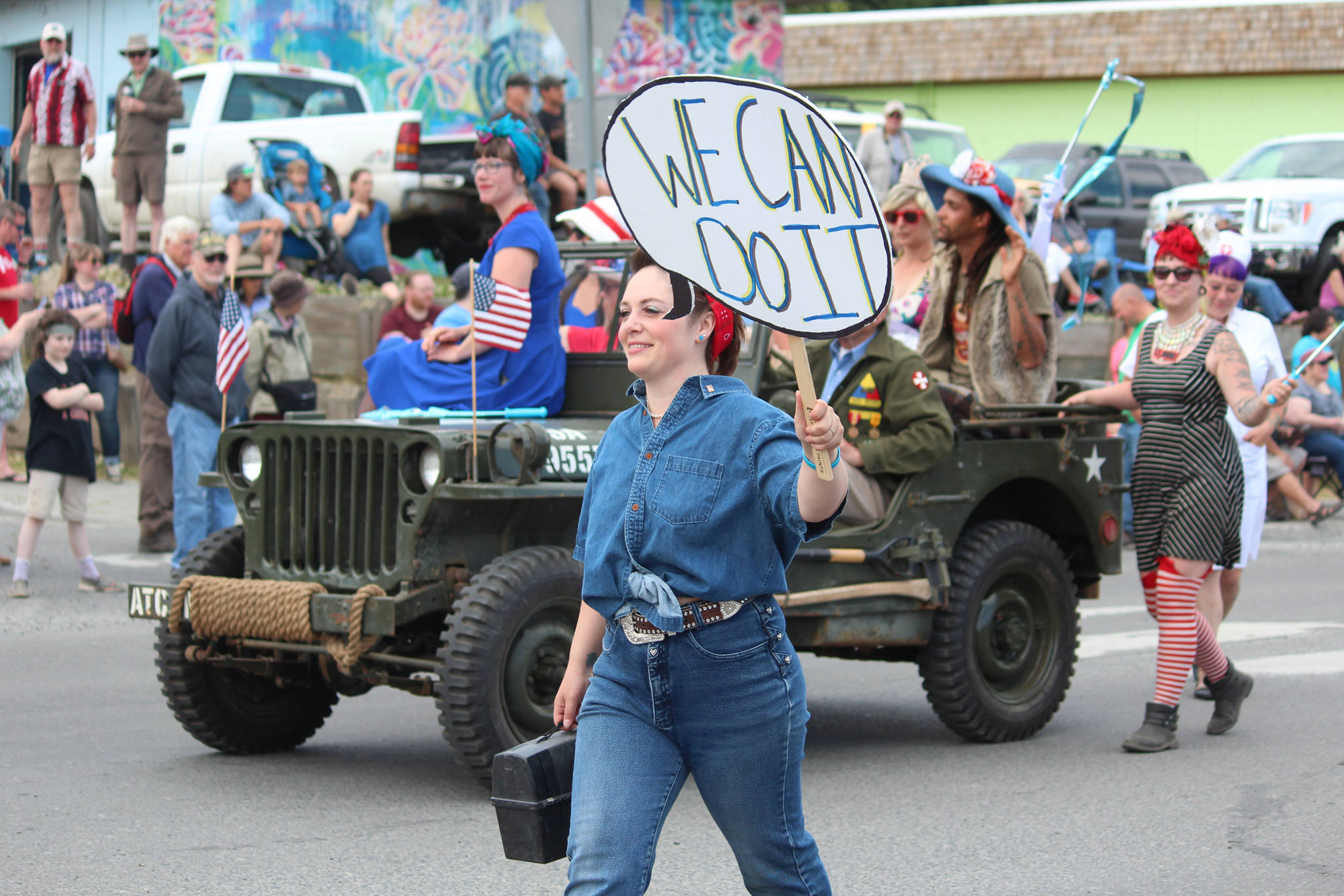 A woman dressed as Rosie the Riveter marches in the July Fourth parade hosted by the Homer Chamber of Commerce on Thursday, July 4, 2019 on Pioneer Avenue in Homer, Alaska. (Photo by Megan Pacer/Homer News)