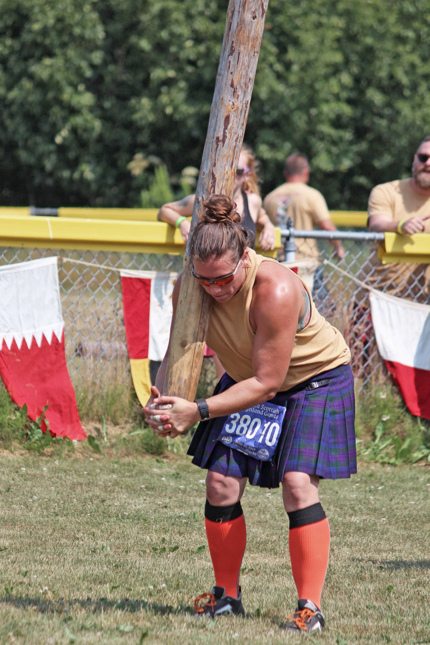 Chrystal Rubert of Washington State picks up a caber and prepares to throw it during the women’s caber toss event.