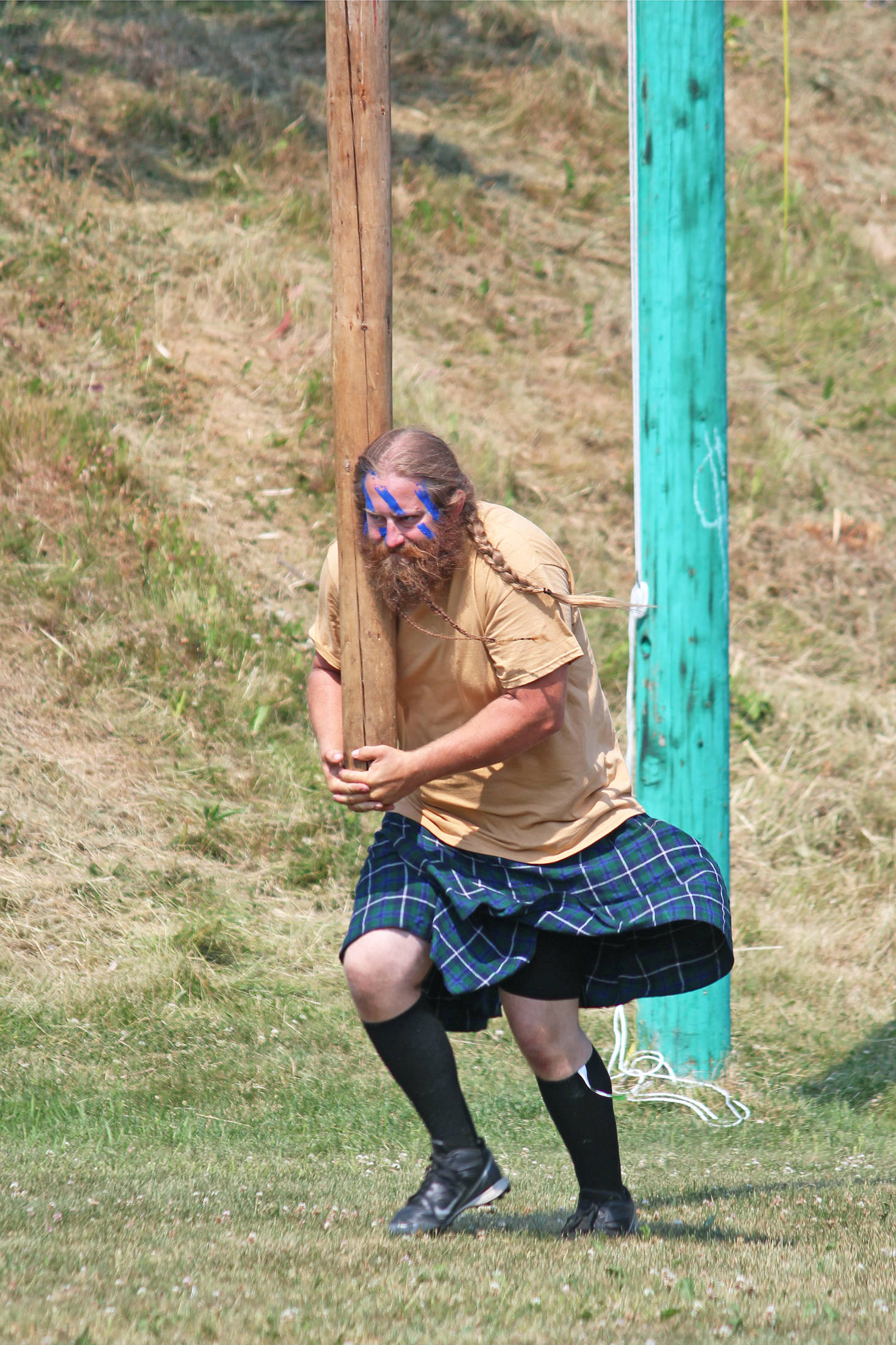 Charles Knefelkamp walks a caber forward before throwing it during the men’s caber toss event at the Kachemak Bay Highland Games on Saturday, July 6, 2019 at Karen Hornaday Park in Homer, Alaska. (Photo by Megan Pacer/Homer News)