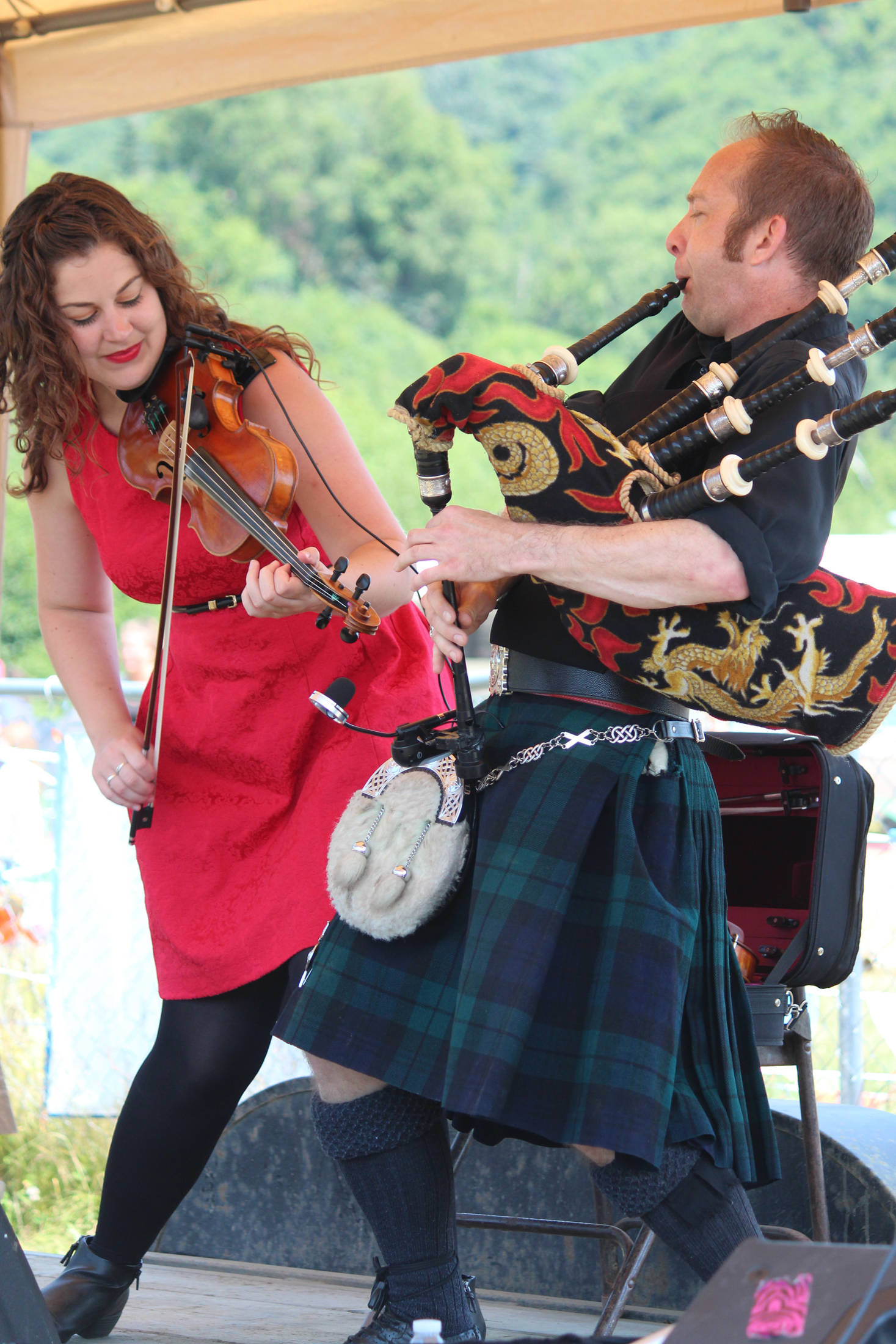 Rebecca Lomnicky and David Brewer of the Scottish music band The Fire perform along with bandmate Adam Hendey for the annual Kachemak Bay Highland Games on Saturday, July 6, 2019 at Karen Hornaday Park in Homer, Alaska. (Photo by Megan Pacer/Homer News)