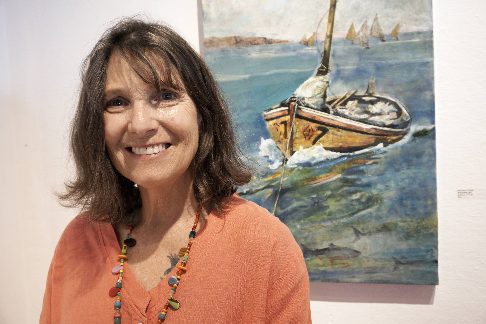Photo by Michael Armstrong/Homer News                                Antoinette Walker poses by one of her encaustic paintings, “Diamond #7,” at the First Friday opening of her exhibit on July 5, 2019, at Bunnell Street Arts Center in Homer, Alaska.