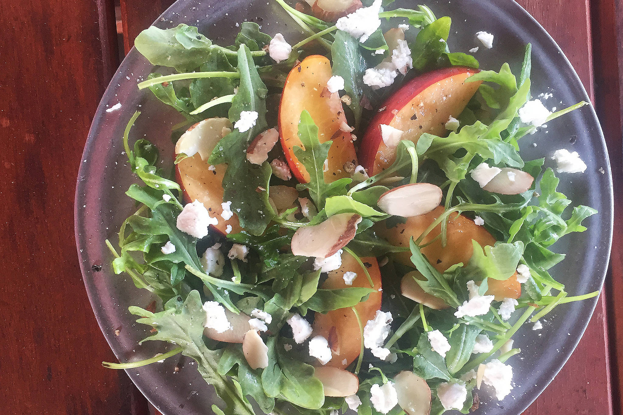 An arugula, peach and goat cheese salad, shown here in Teri Robl’s home in Homer, Alaska. (Photo by Teri Robl)