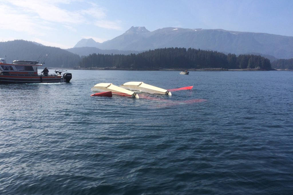 A de Havilland Beaver aircraft floats upside down near the mouth of Tutka Bay, across Kachemak Bay from Homer, Alaska, on Friday, July 19, 2019. The plane had an accident during takeoff with seven people on board. (Photo courtesy Robert Williams)