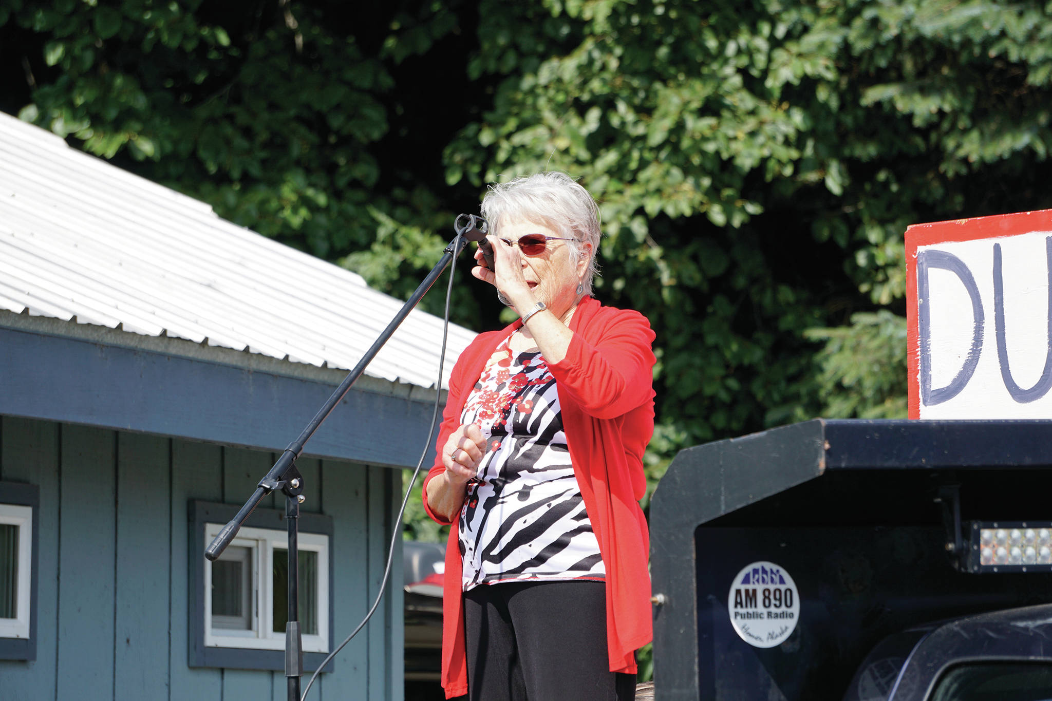 Former Kenai Peninsula Borough Assembly member Milli Martin speaks at a rally Sunday, July 28, 2019, against Gov. Mike Dunleavy’s budget cuts at the Legislative Information Office, Homer, Alaska. (Photo by Michael Armstrong/Homer News).