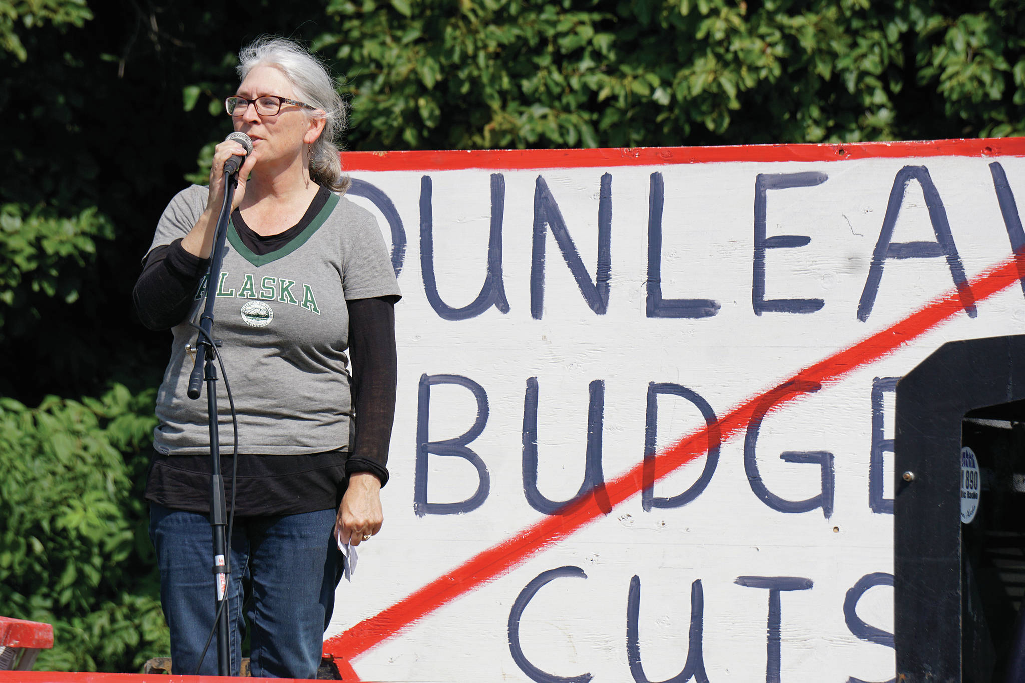Teresa Sundmark speaks about support the University of Alaska at a rally Sunday, July 28, 2019, against Gov. Mike Dunleavy’s budget cuts at the Legislative Information Office, Homer, Alaska. (Photo by Michael Armstrong/Homer News).