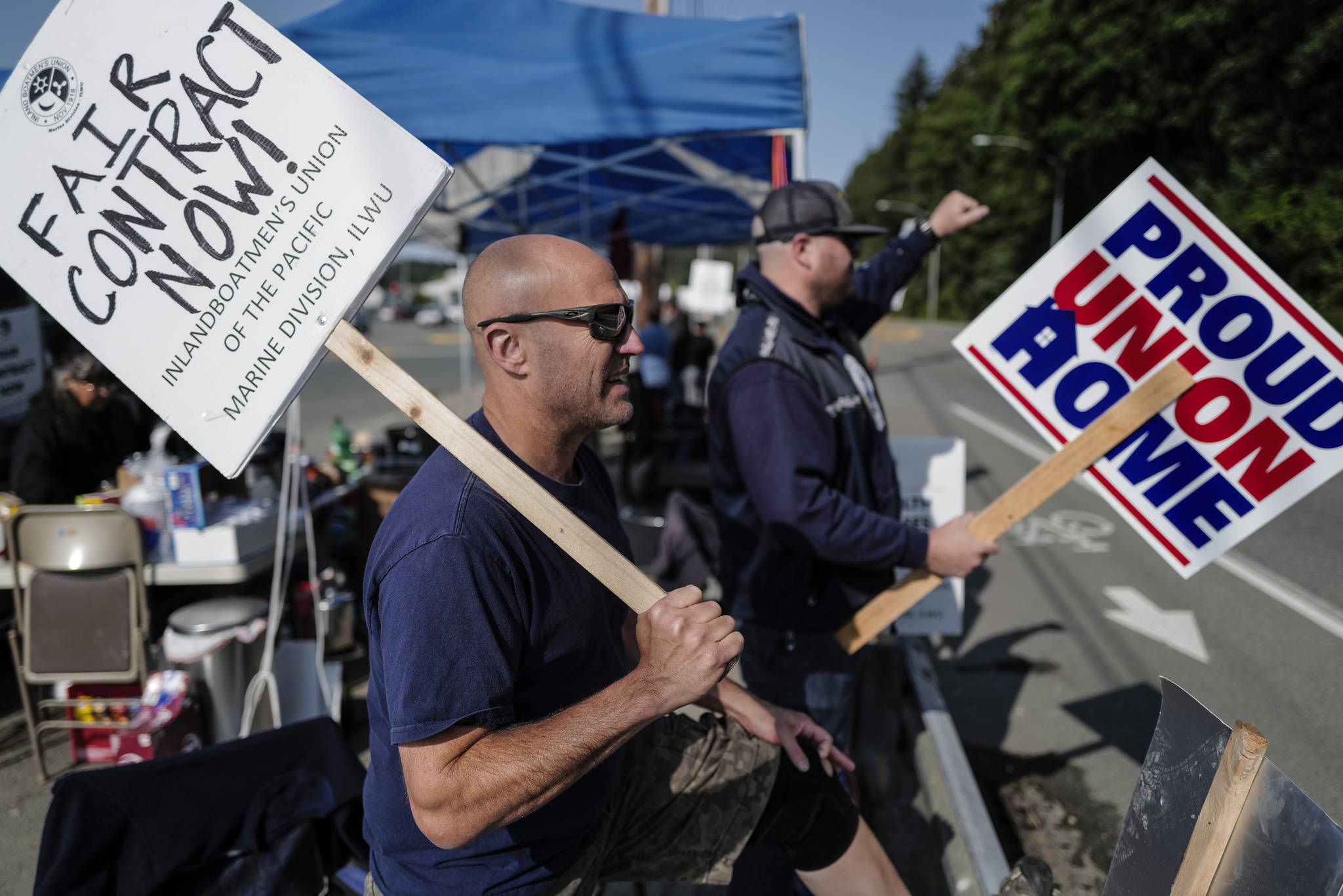 John Vercessi, left, and Dave Bell man the picket line for the Inlandboatmen’s Union of the Pacific at the Alaska Marine Highway System’s Auke Bay Terminal on Tuesday, July 30, 2019. Vercessi works as a seaman on the MV LeConte and Bell is a relief boatswain. (Michael Penn | Juneau Empire)