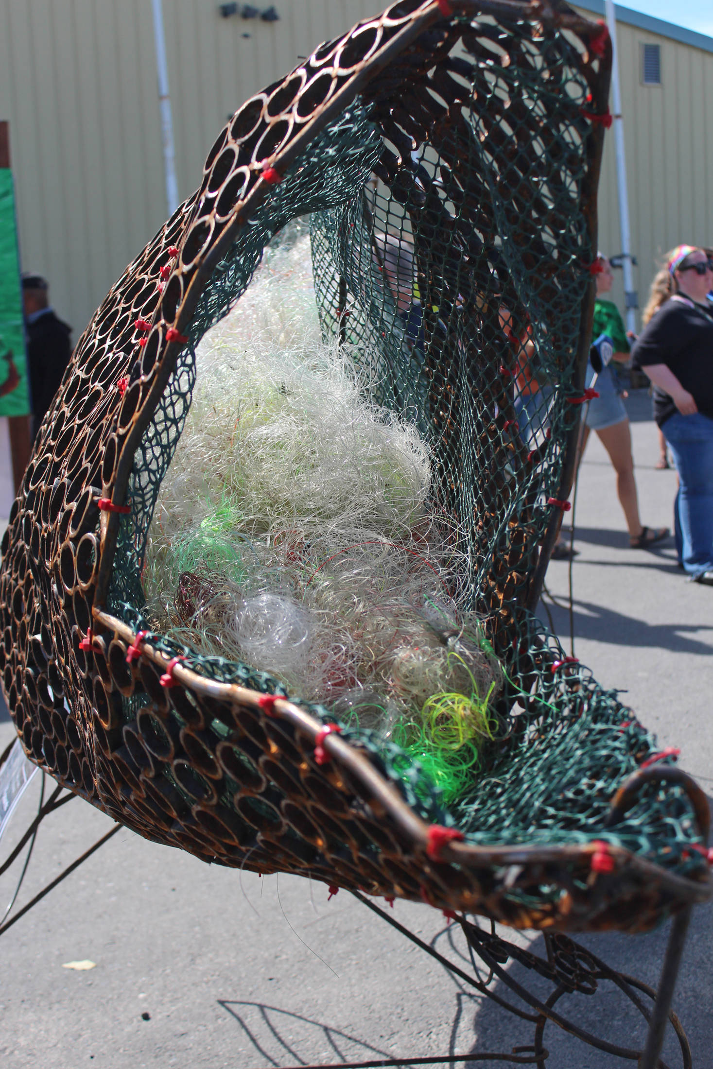 “Sally,” a salmon statue in front of the Kenai Watershed tent, serves as a reminder to passersby about the importance of keeping the oceans clean of fishing line on Friday, Aug. 2, 2019 at Salmonfest in Ninilchik, Alaska. (Photo by Megan Pacer/Homer News)