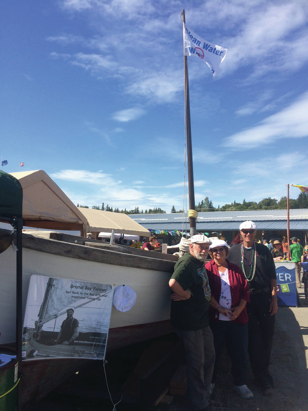 From left, Tim Troll, Kate Mitchell and Dave Seaman, stand in front of LML 144 on Sunday, Aug. 4, 2019, at Salmonfest in Ninilchik, Alaska. They are organizing “Sailing Back to the Bay 2020,” which will take the one-time fishing vessel from Homer to Bristol Bay. (Photo by McKibben Jackinsky)