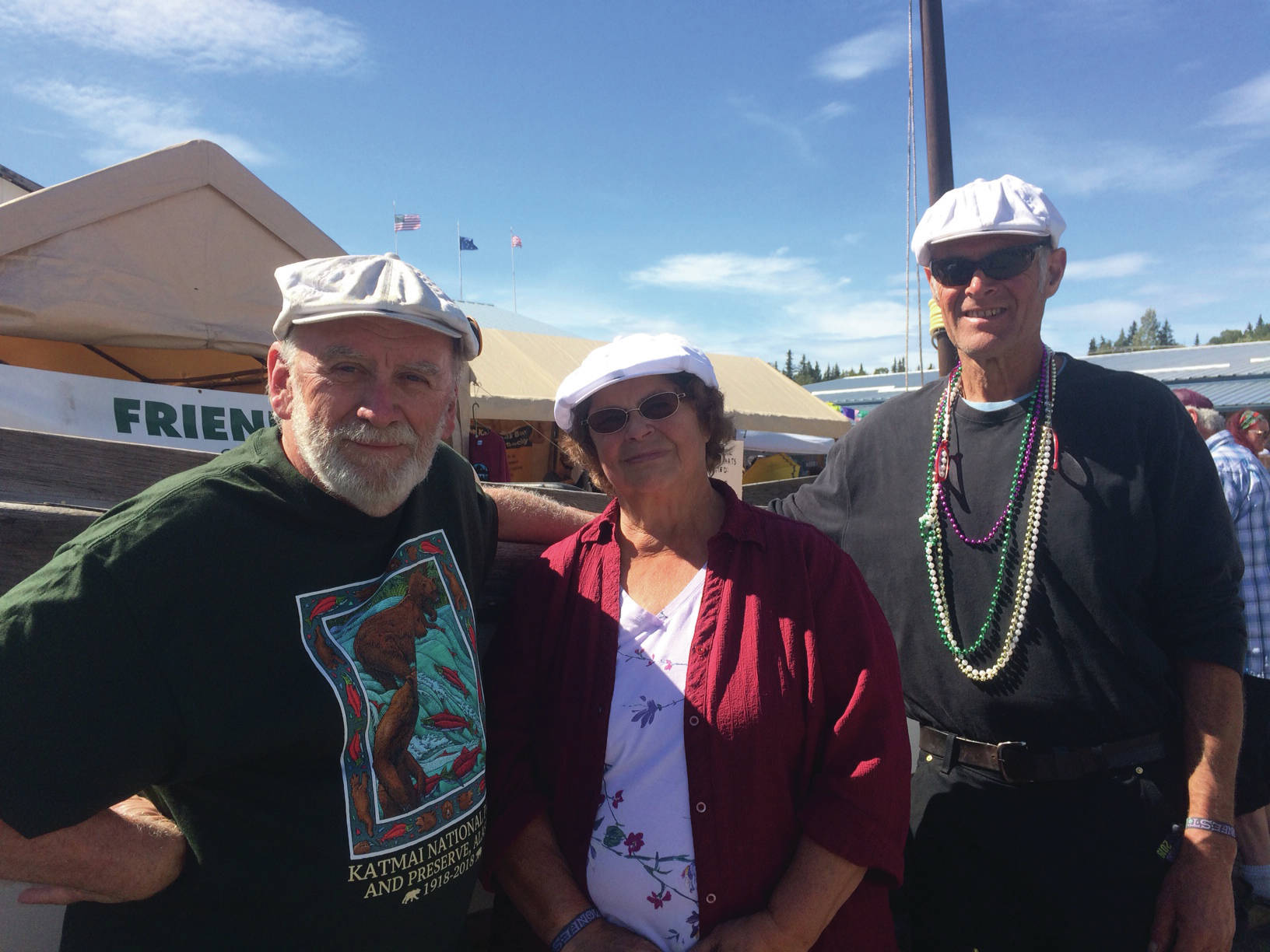 From left, Tim Troll, Kate Mitchell and Dave Seaman stand in front of LML 144 on Sunday, Aug. 4, 2019, at Salmonfest in Ninilchik, Alaska. They are organizing “Sailing Back to the Bay 2020,” which will take the one-time fishing vessel from Homer to Bristol Bay. (Photo by McKibben Jackinsky)