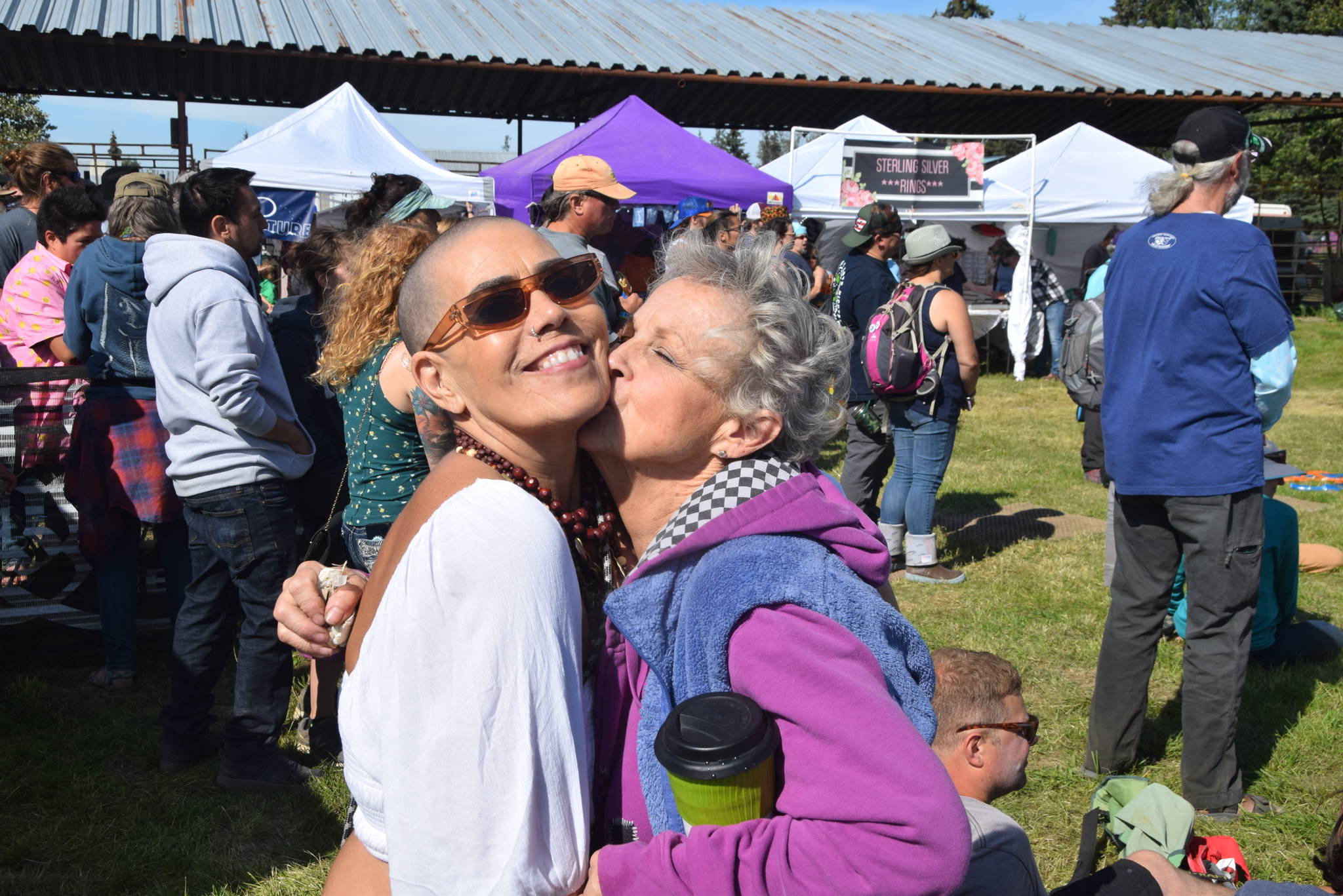 Monet Barbee, left and Judy Casey, right, pose for the camera during Salmonfest 2019 in Ninilchik, Alaska on August 2, 2019. (Photo by Brian Mazurek/Peninsula Clarion)