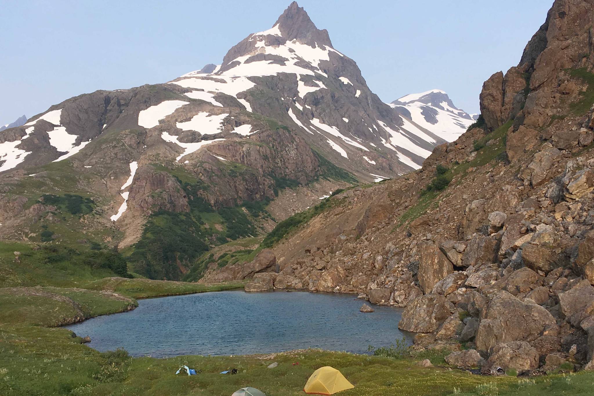 A pair of tents sits at the Infinity Pools above the Tutka Backdoor Trail across Kachemak Bay from Homer, Alaska, on July 9, 2019. (Photo by Jeff Helminiak/Peninsula Clarion)