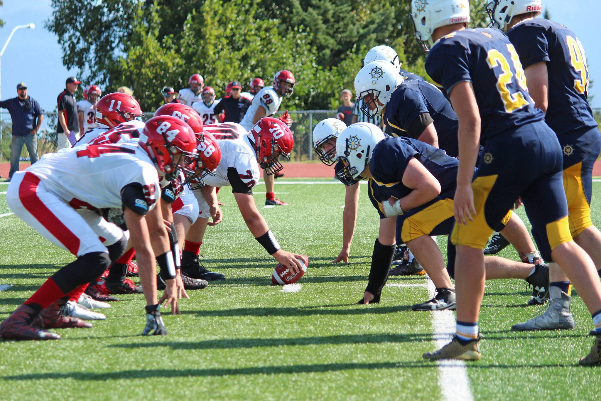 Photo by Megan Pacer/Homer News                                 The Kenai Kardinals (left) and Homer Mariners face off against each other in their first varsity football game on the season Saturday, Aug. 17, 2019 in Homer, Alaska.