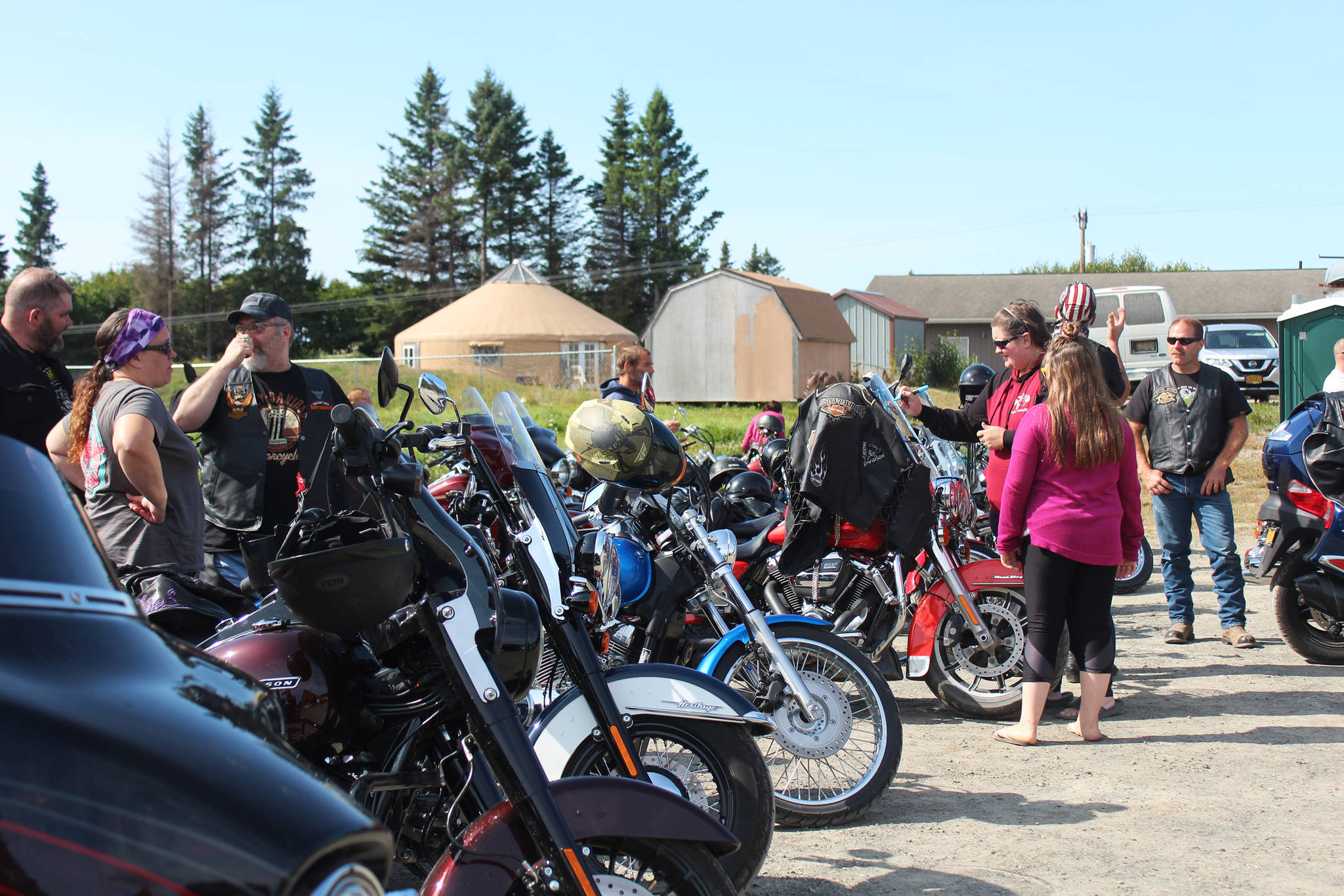 Bike riders and community members look at the myriad motorcycles assembled for the inaugural Homer Suicide Awareness and Prevention Ride and Drive on Saturday, Aug. 17, 2019 starting at the Homer Christian Church on East End Road in Homer, Alaska. (Photo by Megan Pacer/Homer News)
