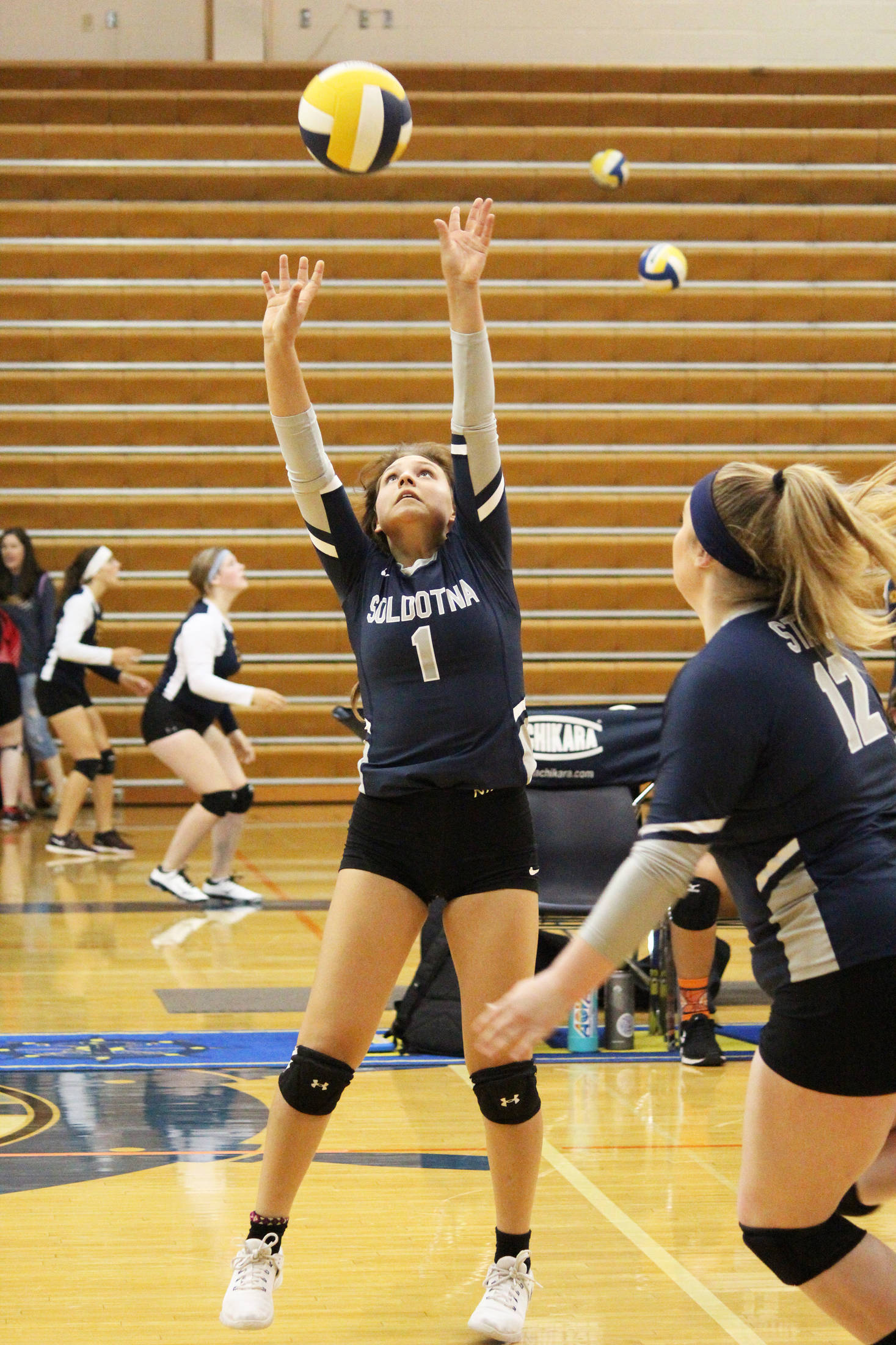 Soldotna’s Hosanna Van Hout sets the ball during a Saturday, Aug. 24, 2019 volleyball game Saturday, Aug. 24, 2019 during the Homer Jamboree tournament at the Alice Witt Gymnasium in Homer, Alaska. (Photo by Megan Pacer/Homer News)