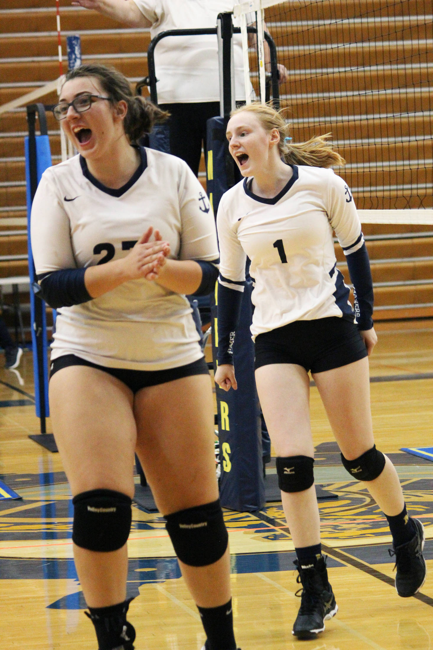 Homer volleyball players Tonda Smude (left) and Kelli Bishop (right) celebrate earning a point in a Saturday, Aug. 24, 2019 game against Nikiski Middle High School during the Homer Jamboree tournament at the Alice Witt Gymnasium in Homer, Alaska. (Photo by Megan Pacer/Homer News)