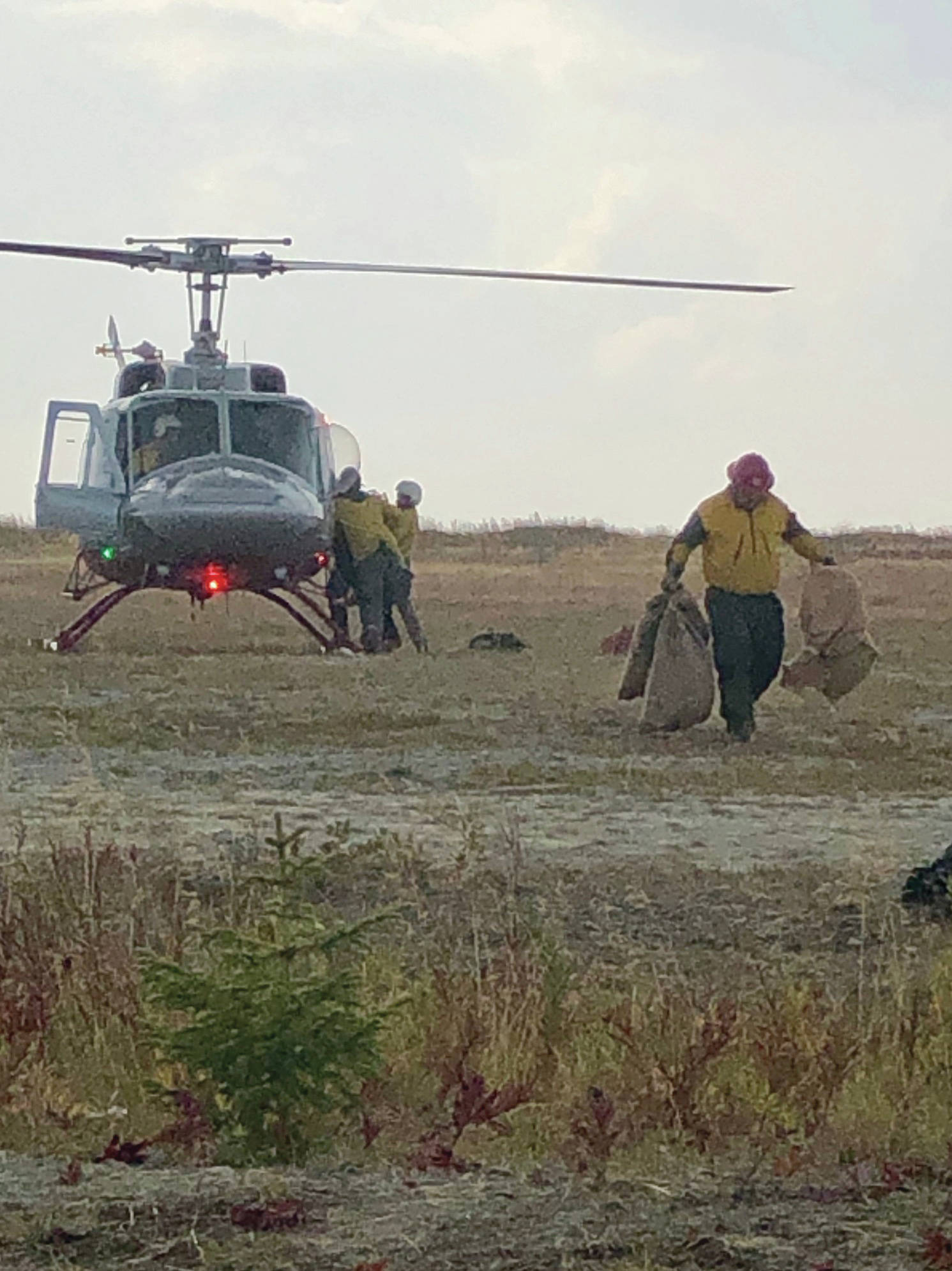 Firefighters unload supplies from a helicopter at the Caribou Lake Fire on Monday, Aug 26, 2019, northeast of Homer, Alaska. (Photo by Sarah Saarloos/Alaska Division of Forestry)