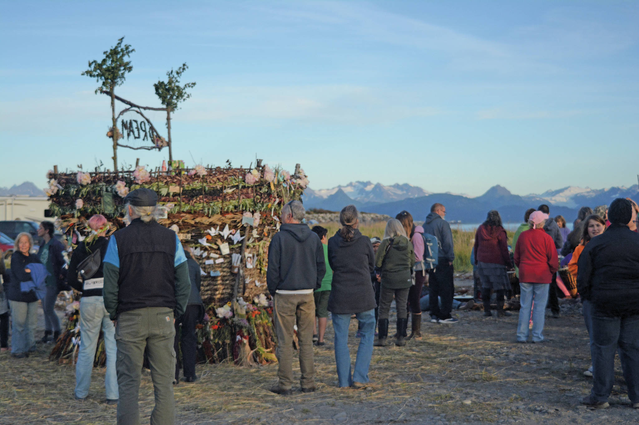 Visitors interact with the 2018 Burning Basket, Dream, on Sept. 9, 2018, at Mariner Park in Homer, Alaska. (Photo by Michael Armstrong/Homer News)