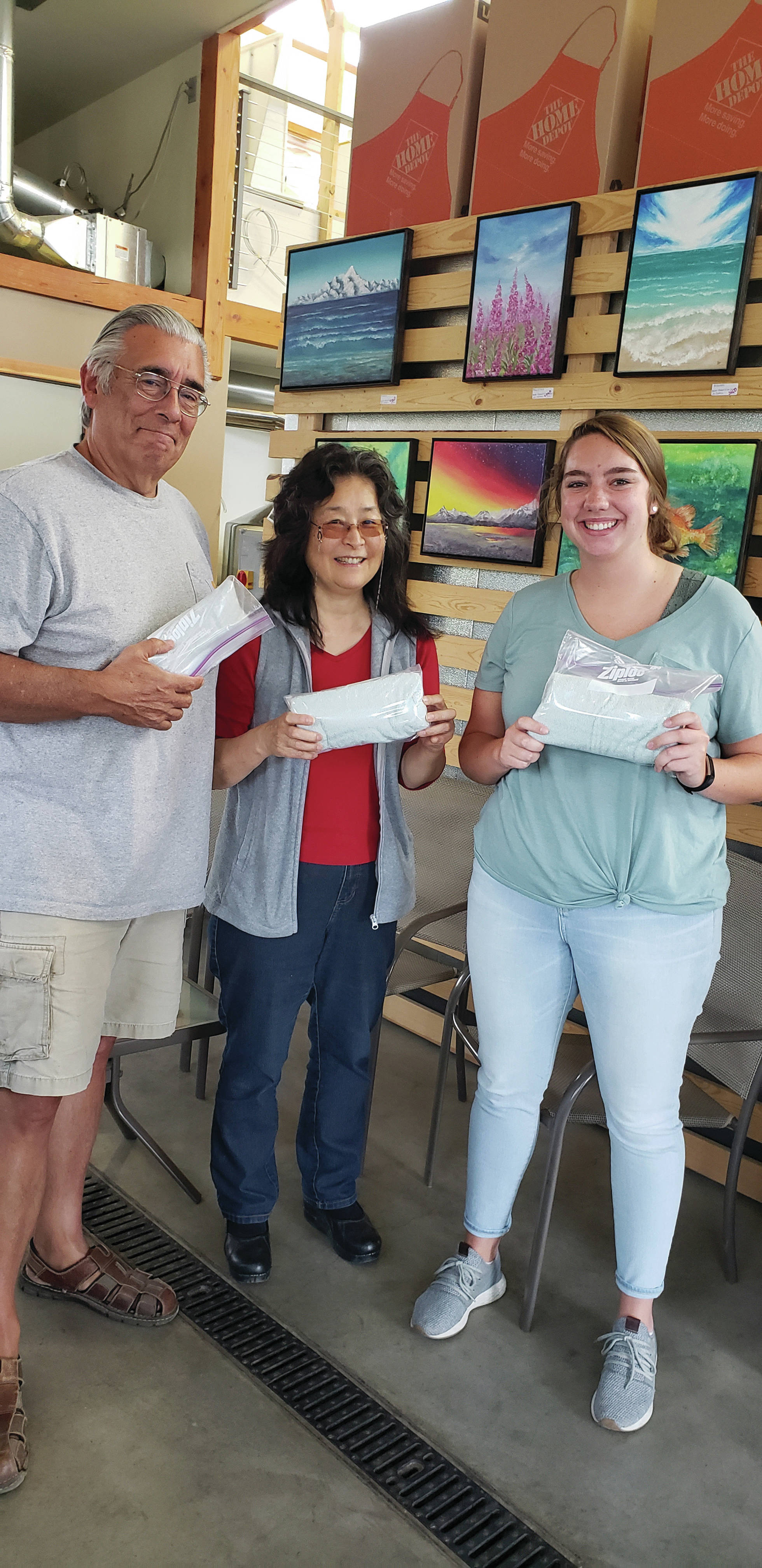 Hal and Lynn Spence and visiting student Sydney Butterfield show examples of three completed hygiene kits that have been sent to the nation’s southern border from Homer. On July 22, 2019, the Spences and Butterfield dropped by 24 completed kits to Grace Ridge Brewery in Homer, Alaska. The kits are distributed by the United Methodist Committee on Relief to transition centers. Monetary donations, items for kits and assembled kits are still being accepted to make a difference at the border. They can be dropped by Grace Ridge Brewing or Homer United Methodist Church. More than 200 kits have been sent from Homer. Another event to help assemble additional kits will be held later in September. (Photo by Sherry Stead)