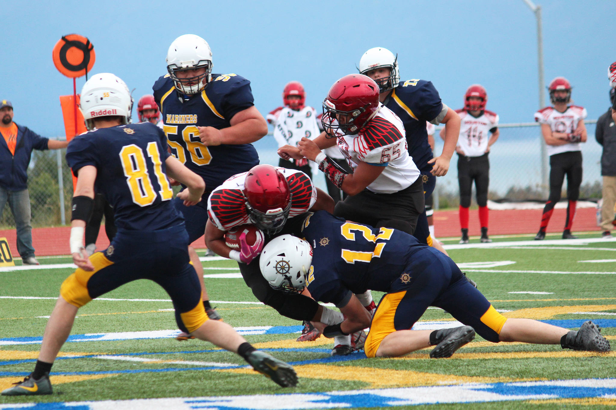 Homer quarterback Anthony Kalugin (12) tackles Houston’s Kennedy Fono during a Friday, Sept. 6, 2019 football game between the two teams on the Mariner field in Homer, Alaska. (Photo by Megan Pacer/Homer News)