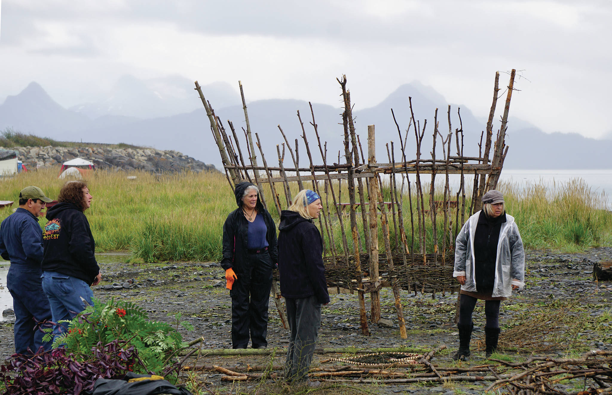 Burning Basket facilitator Mavis Muller, right, guides volunteers in building the 16th annual Burning Basket, Radiate, on Monday, Sept. 9, 2019, at Mariner Park on the Homer Spit in Homer, Alaska. (Photo by Michael Armstrong/Homer News)