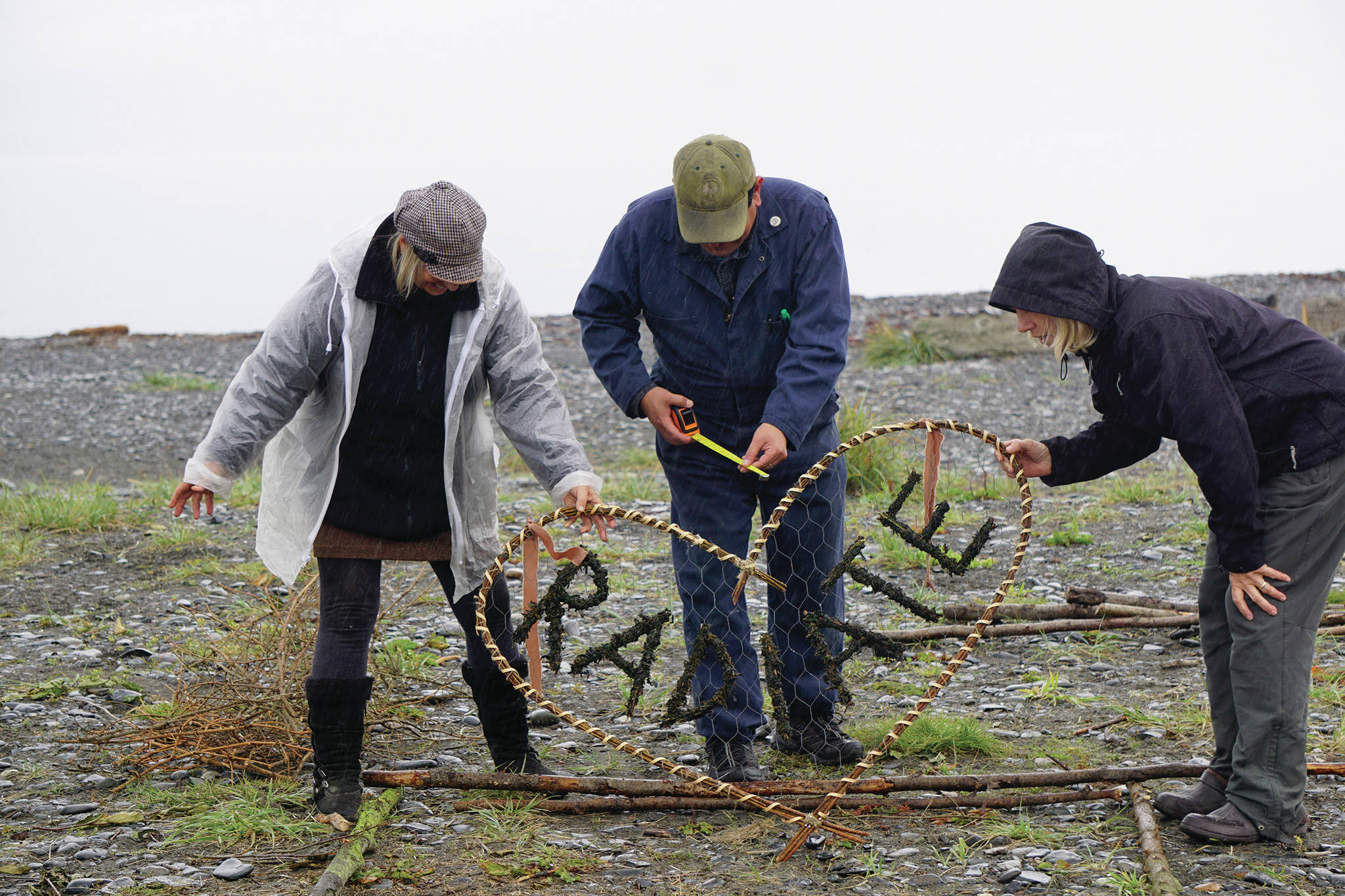 Burning Basket facilitator Mavis Muller, left, works on the sign for the 16th annual Burning Basket, Radiate, on Monday, Sept. 9, 2019, at Mariner Park on the Homer Spit in Homer, Alaska. Helping her are Charles Aguilar, center, and Patty Delate, right. (Photo by Michael Armstrong/Homer News)