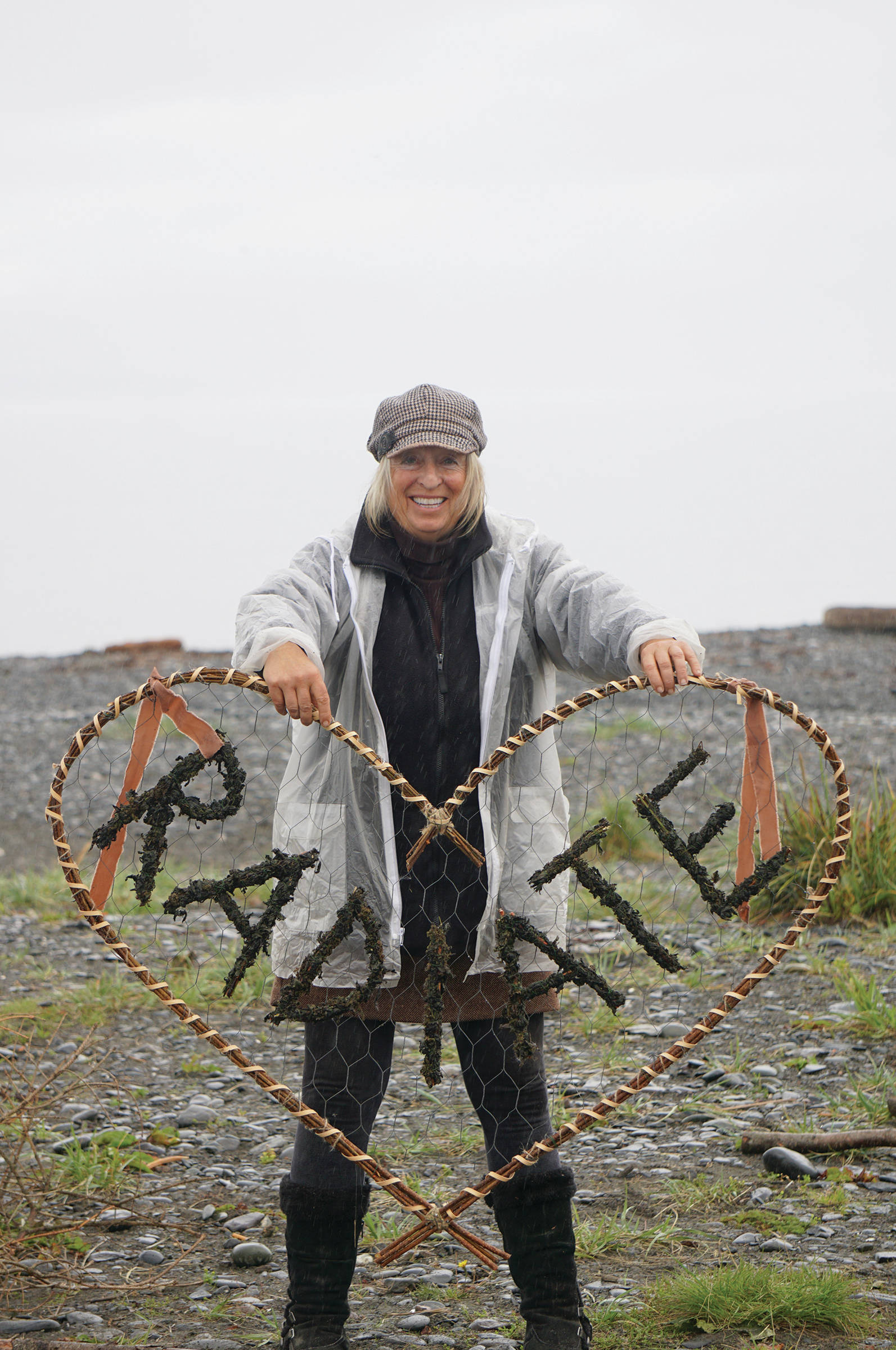 Burning Basket facilitator Mavis Muller holds up the name of the 16th annual Burning Basket, Radiate, on Monday, Sept. 9, 2019, at Mariner Park on the Homer Spit in Homer, Alaska. (Photo by Michael Armstrong/Homer News)