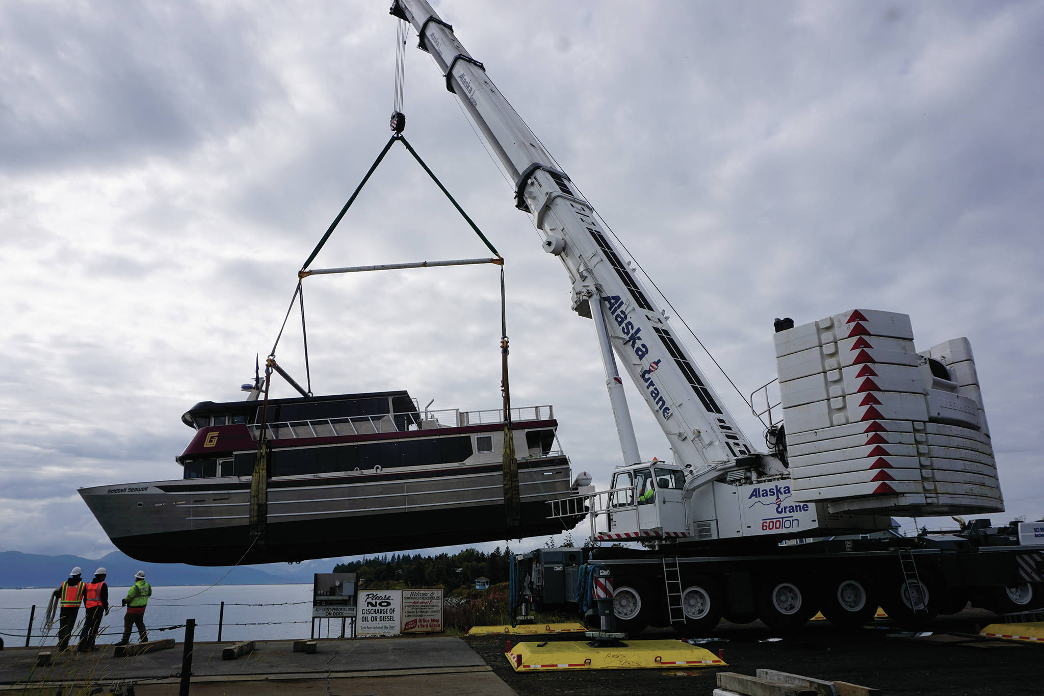 Operators of a Liebherr LTM 1500 mobile hydraulic crane move the Goldbelt Seawolf at its launch on Tuesday, Sept. 10, 2019, at the Northern Enterprises Boatyard in Homer, Alaska. (Photo by Michael Armstrong/Homer News)