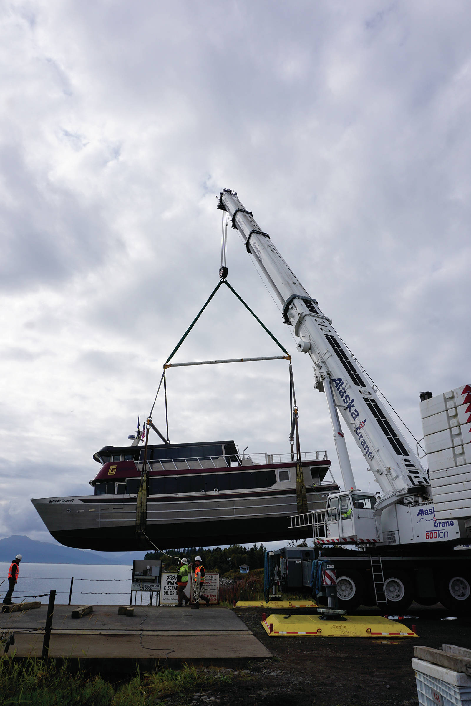 Operators of an Alaska Crane Liebherr LTM 1500 mobile hydraulic crane move the Goldbelt Seawolf at its launch on Tuesday, Sept. 10, 2019, at the Northern Enterprises Boatyard in Homer, Alaska. (Photo by Michael Armstrong/Homer News)