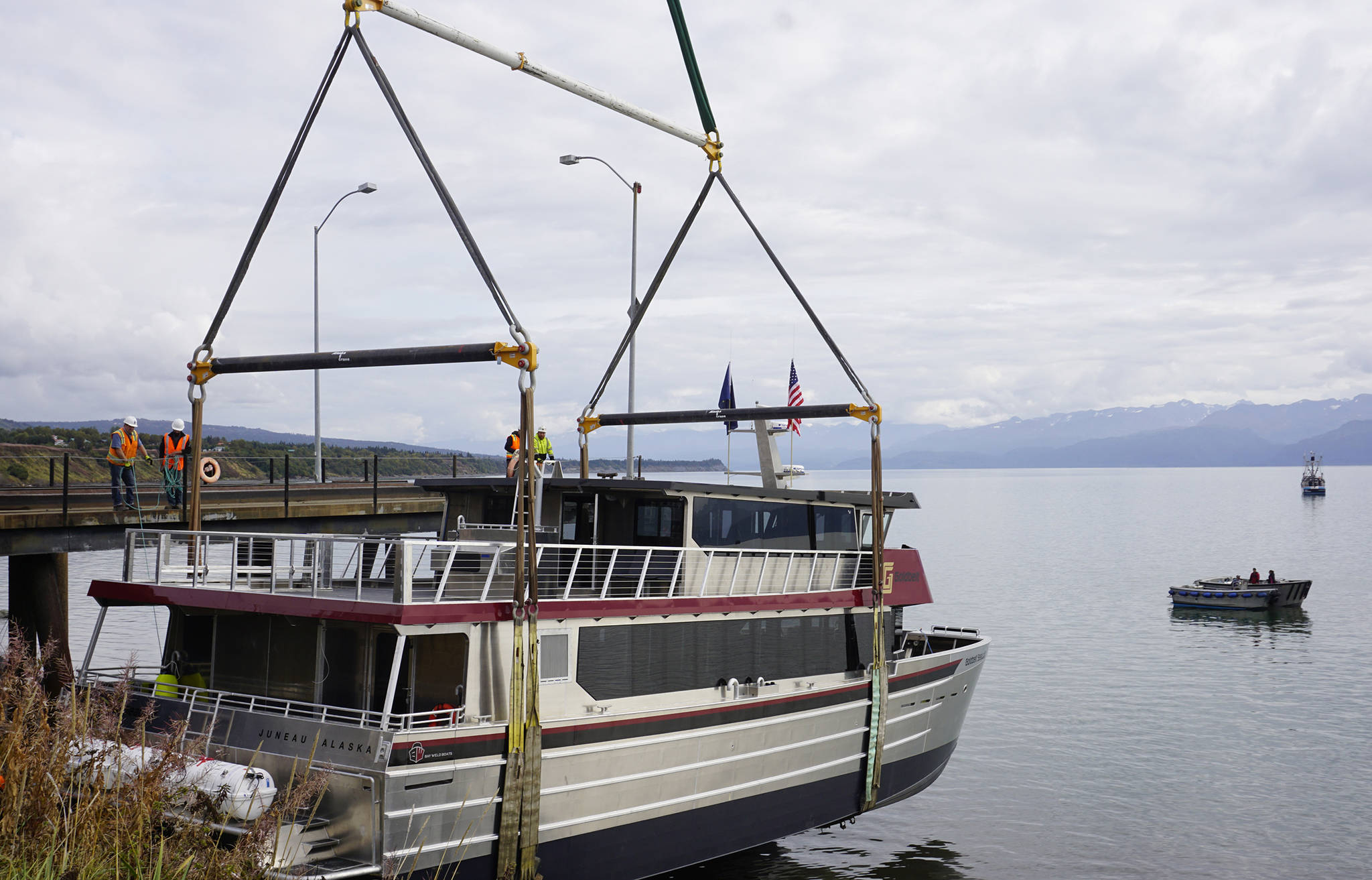 Operators of an Alaska Crane Liebherr LTM 1500 mobile hydraulic crane move the Goldbelt Seawolf at its launch on Tuesday, Sept. 10, 2019, at the Northern Enterprises Boatyard in Homer, Alaska. The crane held the Seawolf over the water until the tide had come in. (Photo by Michael Armstrong/Homer News)