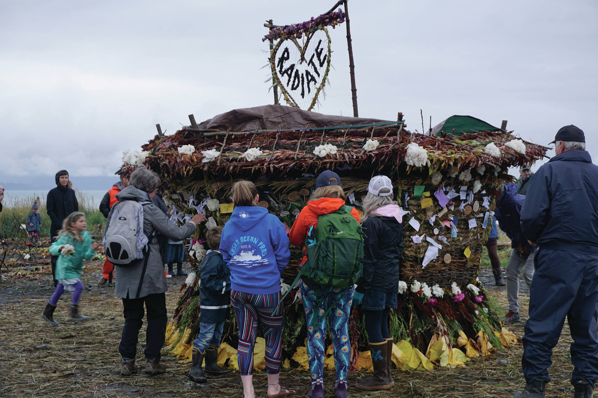 Visitors interact with “Radiate,” the 16th annual Burning Basket, on Sunday night, Sept. 15, 2019, at Mariner Park on the Homer Spit in Homer, Alaska. (Photo by Michael Armstrong/Homer News)