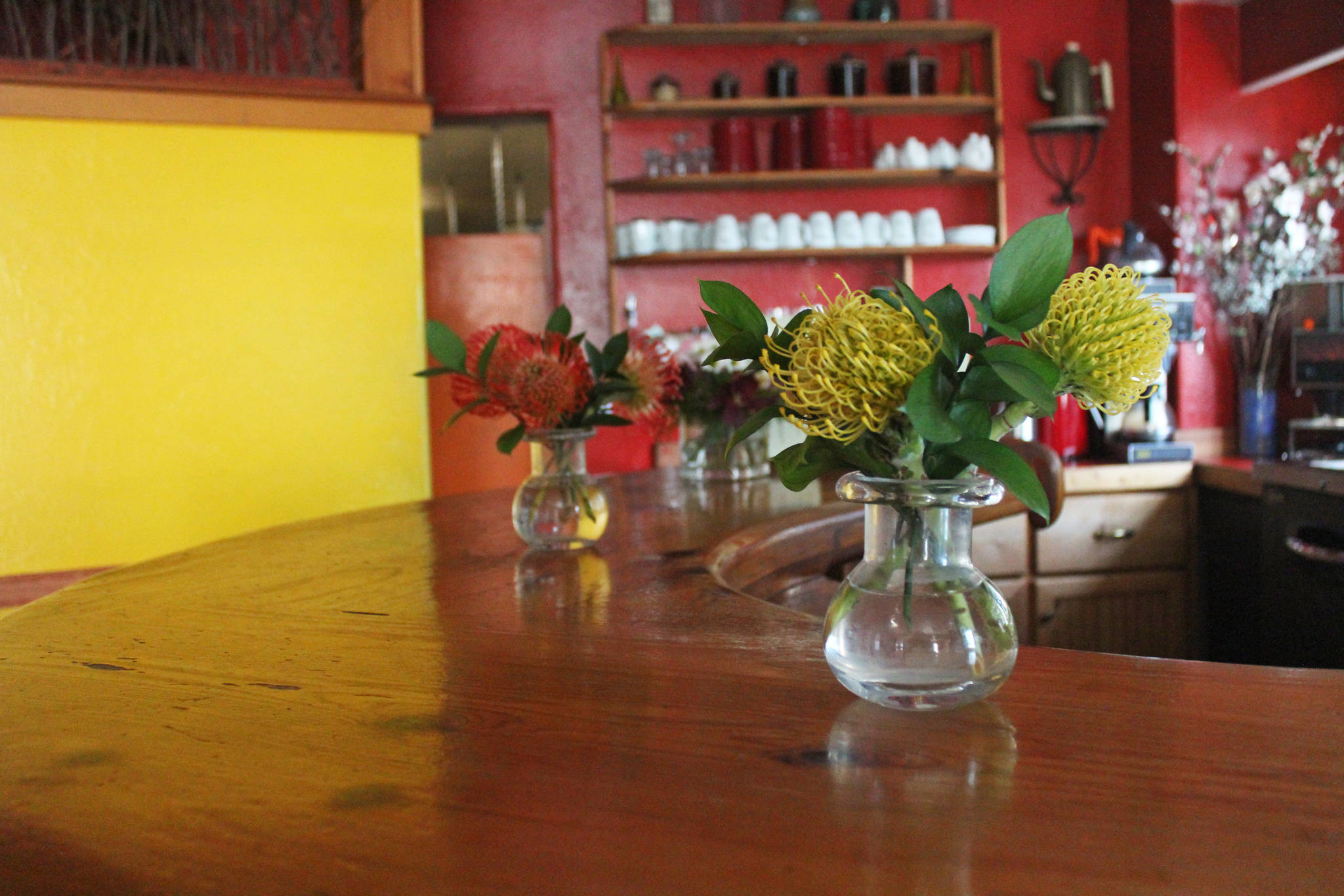 Flowers rest on the counter in Cafe Cups, which closed its doors after its last night of dinner service Saturday, Sept. 14, 2019 on Pioneer Avenue in Homer, Alaska. (Photo by Megan Pacer/Homer News)