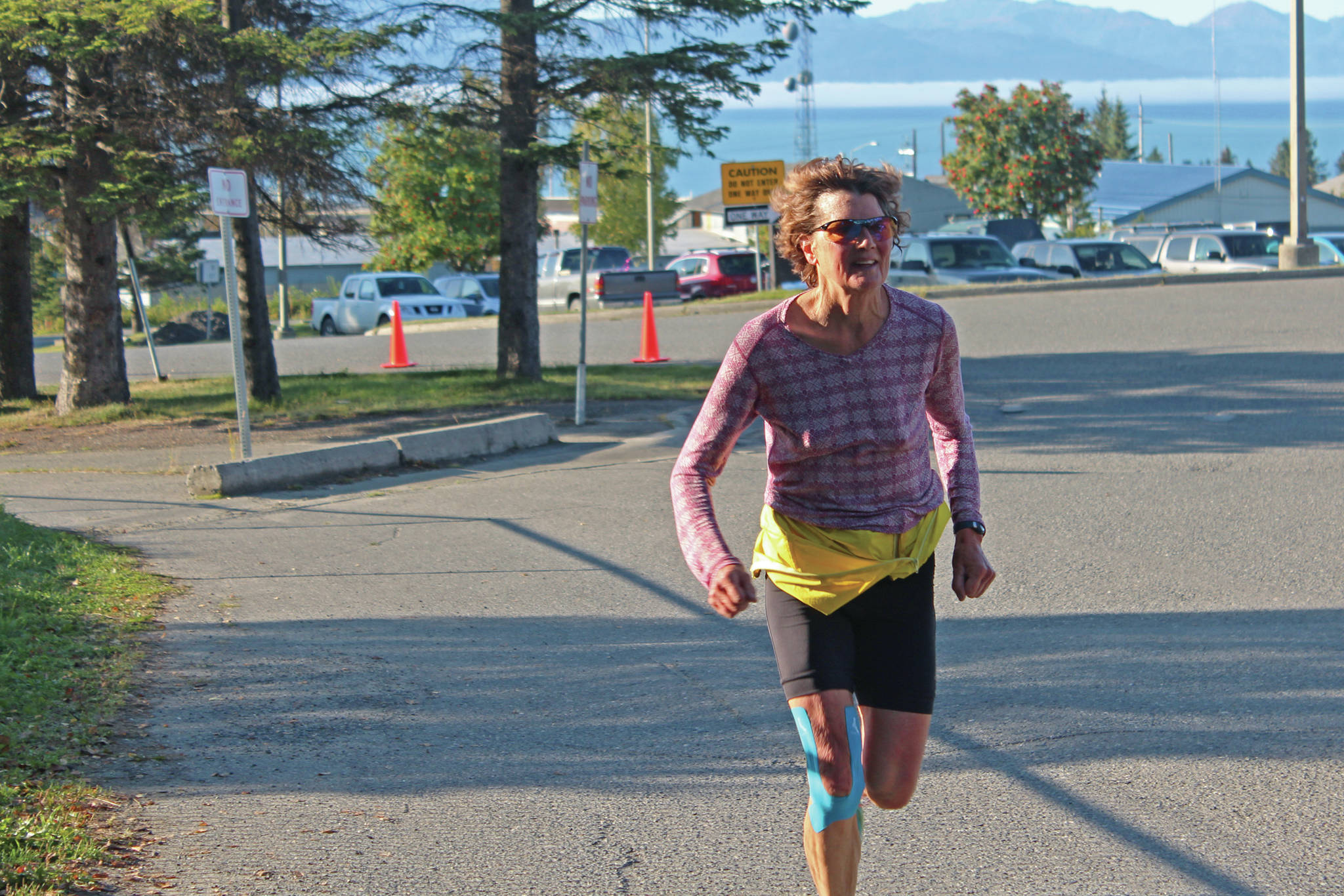 Jane Wiebe runs to the finish line of the Homer Mariner Triathlon on Saturday, Sept. 14, 2019 in Homer, Alaska. (Photo by Megan Pacer/Homer News)